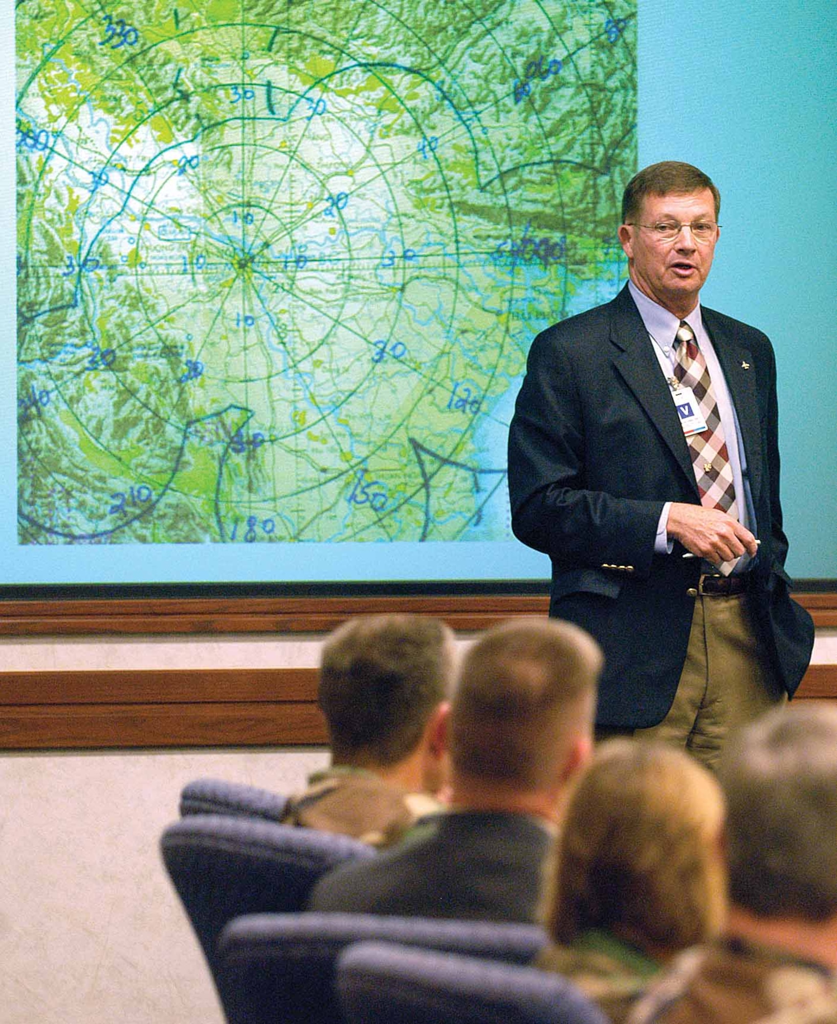 Retired colonel Chuck DeBellevue relives experiences during the Vietnam War and shares learned lessons on leadership during his April 9 presentation to the Tinker Senior Leader Forum.  Mr. DeBellevue was the first Air Force weapons systems officer to become an ace in the Vietnam War and in 1972 earned the Mackay Trophy.  (Air Force photo by Margo Wright)


