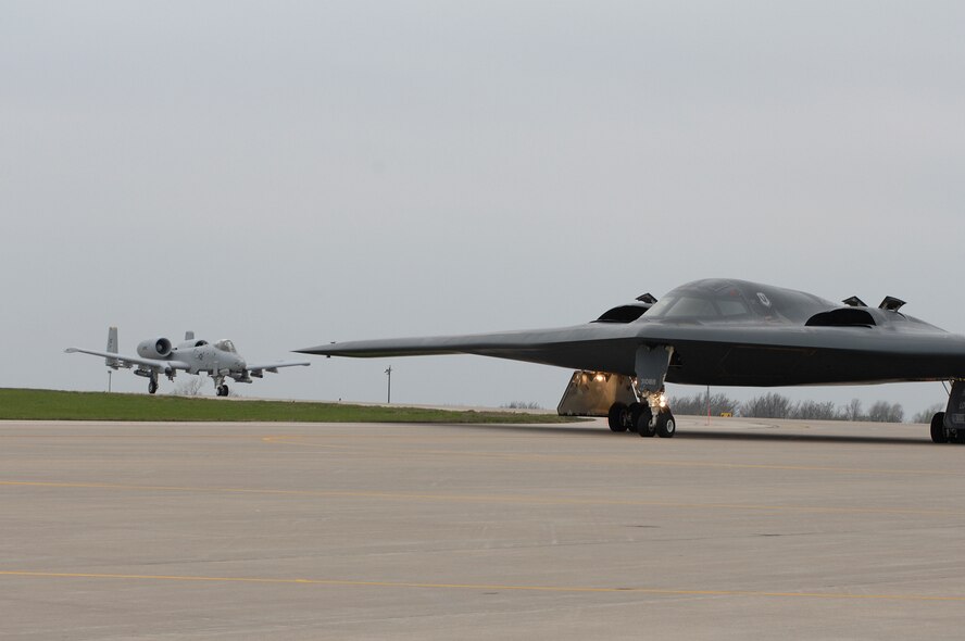WHITEMAN AIR FORCE BASE, Mo., - The B-2 “Spirit of Louisiana” flown by Lt. Col. Frank Cavuoti, mission commander, and Capt. Todd Moenster, pilot, taxi to the runway Apr. 17. In the background, a 442nd Fighter Wing A-10 piloted by Col. John Hoff, call-sign Strike 01, follows directly after. The B-2 regularly shares the runway with the 442nd FW's A-10s and T-38s. The B-2 returned to flying April 15 following a 53-day safety pause, after the first-ever crash Feb. 23 in Guam. (U.S. Air Force photo/Tech. Sgt. Samuel A. Park) 