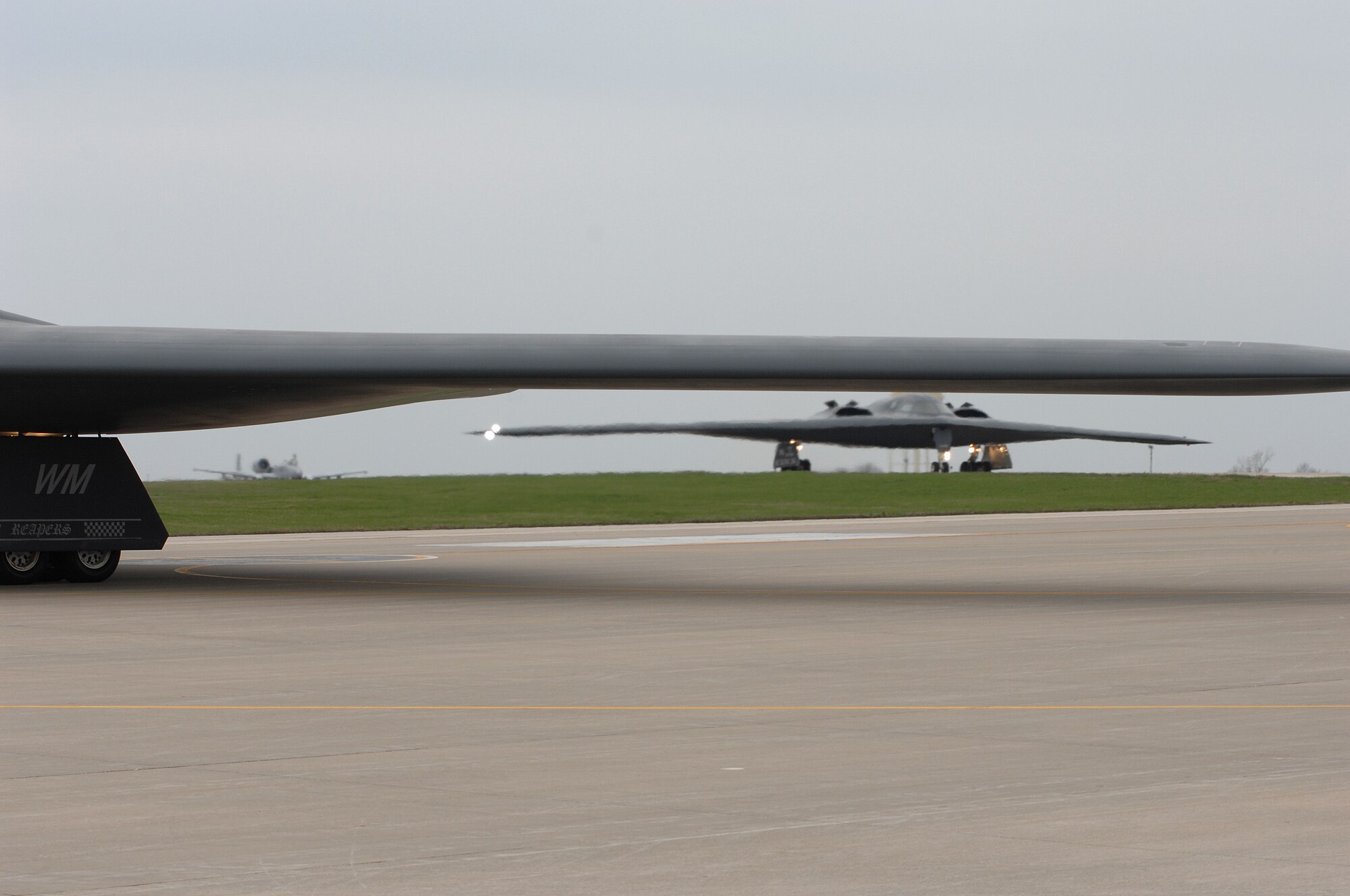 WHITEMAN AIR FORCE BASE, Mo., - The B-2 “Spirit of Florida” flown by Lt. Col. Brian Copello, mission commander, and Capt. John Avery, pilot, taxi to the runway Apr. 17. In the background, the B-2 “Spirit of Louisiana” flown by Lt. Col. Frank Cavuoti, mission commander, and Capt. Todd Moenster, pilot, follows directly after. The B-2 returned to flying April 15 following a 53-day safety pause, after the first-ever crash Feb. 23 in Guam. (U.S. Air Force photo/Tech. Sgt. Samuel A. Park)