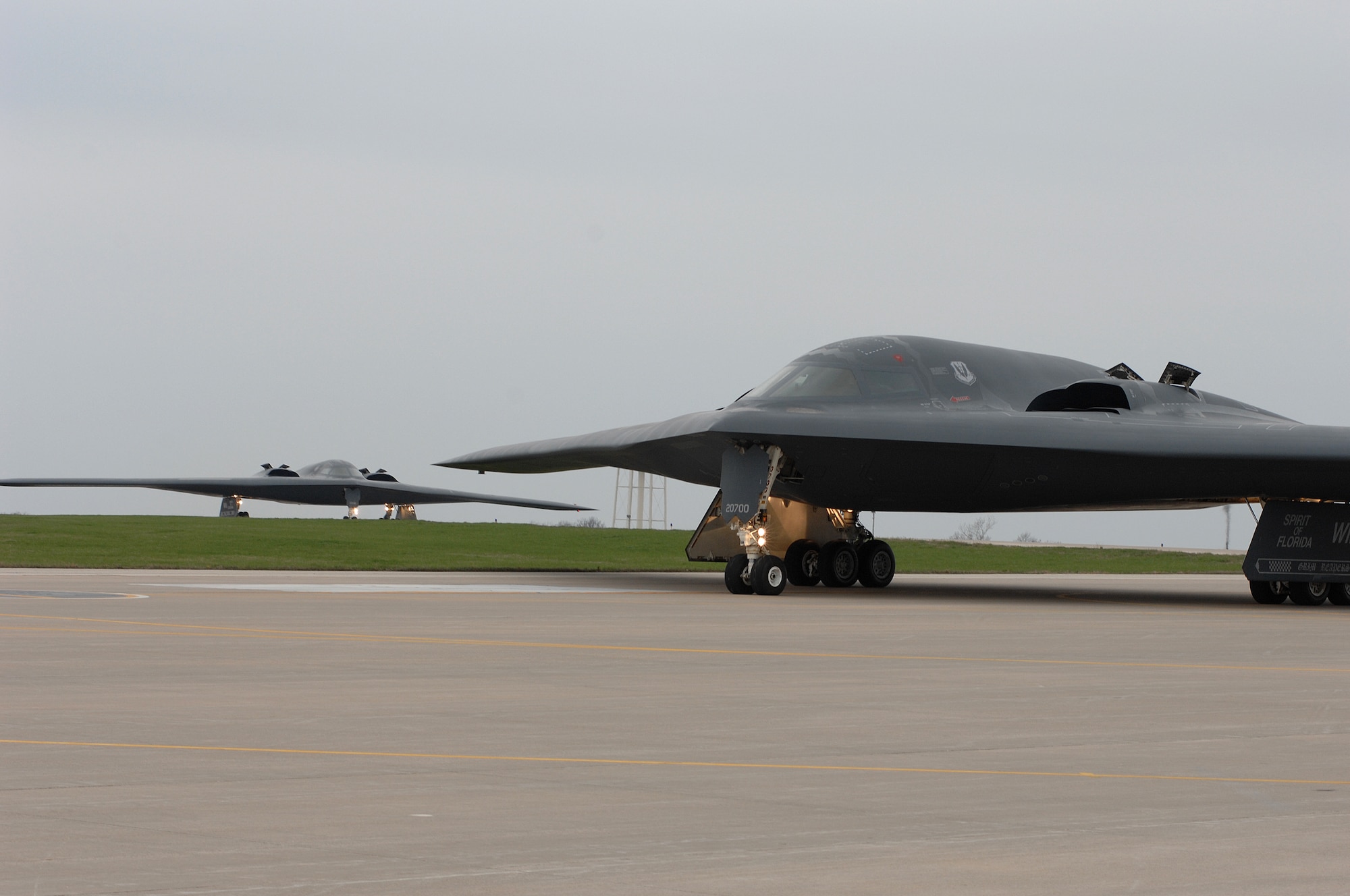 WHITEMAN AIR FORCE BASE, Mo., - The B-2 “Spirit of Florida” flown by Lt. Col. Brian Copello, mission commander, and Capt. John Avery, pilot, taxi to the runway Apr. 17. In the background, the B-2 “Spirit of Louisiana” flown by Lt. Col. Frank Cavuoti, mission commander, and Capt. Todd Moenster, pilot, follows directly after. The B-2 returned to flying April 15 following a 53-day safety pause, after the first-ever crash Feb. 23 in Guam. (U.S. Air Force photo/Tech. Sgt. Samuel A. Park)