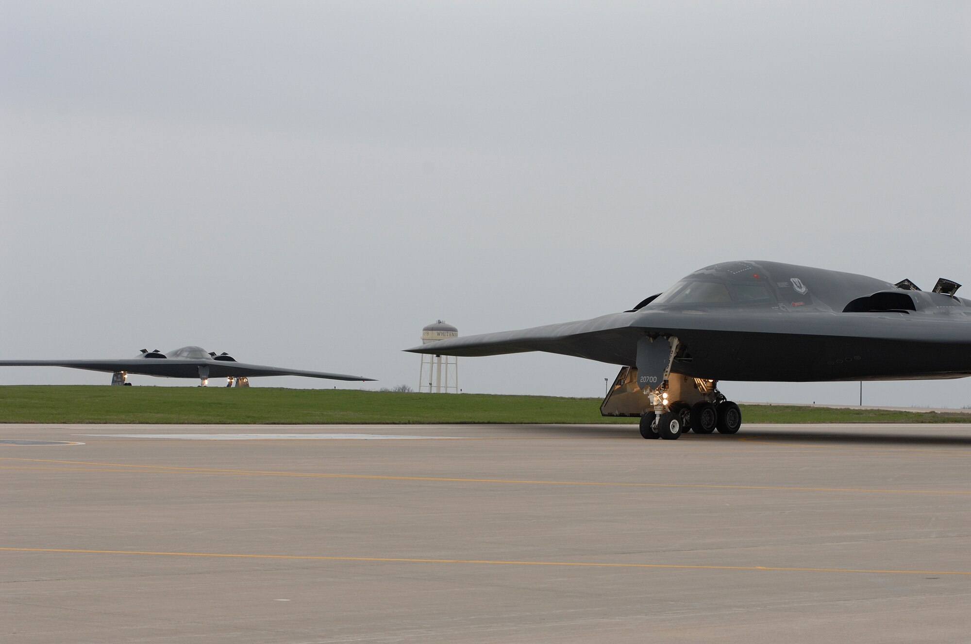 WHITEMAN AIR FORCE BASE, Mo., - The B-2 “Spirit of Florida” flown by Lt. Col. Brian Copello, mission commander, and Capt. John Avery, pilot, taxi to the runway Apr. 17. In the background, the B-2 “Spirit of Louisiana” flown by Lt. Col. Frank Cavuoti, mission commander, and Capt. Todd Moenster, pilot, follows directly after. The B-2 returned to flying April 15 following a 53-day safety pause, after the first-ever crash Feb. 23 in Guam. (U.S. Air Force photo/Tech. Sgt. Samuel A. Park)