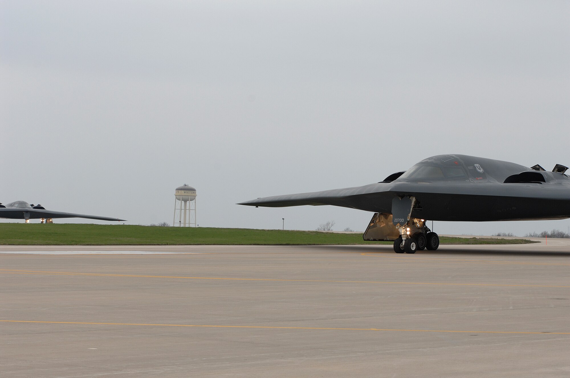 WHITEMAN AIR FORCE BASE, Mo., - The B-2 “Spirit of Florida” flown by Lt. Col. Brian Copello, mission commander, and Capt. John Avery, pilot, taxi to the runway Apr. 17. In the background, the B-2 “Spirit of Louisiana” flown by Lt. Col. Frank Cavuoti, mission commander, and Capt. Todd Moenster, pilot, follows directly after. The B-2 returned to flying April 15 following a 53-day safety pause, after the first-ever crash Feb. 23 in Guam. (U.S. Air Force photo/Tech. Sgt. Samuel A. Park)