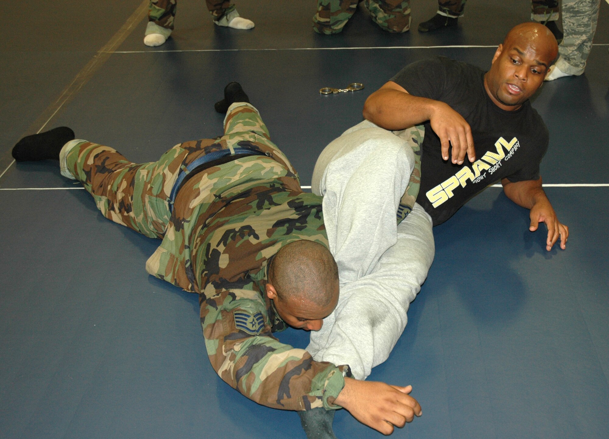 Carlos Cummings, martial arts instructor and owner of Cummings Combat Sambo, puts Staff Sgt. Deante Brooks, 325th Security Forces Squadron patrolman, into an arm hold during self-defense class Mr. Cummings taught to various patrolmen from the 325th SFS. As part of the changing mission of security forces, classes  like Mr. Cummings are becoming a more frequent part of security forces training.  (U.S. Air Force photo/Staff Sgt. Timothy R. Capling)