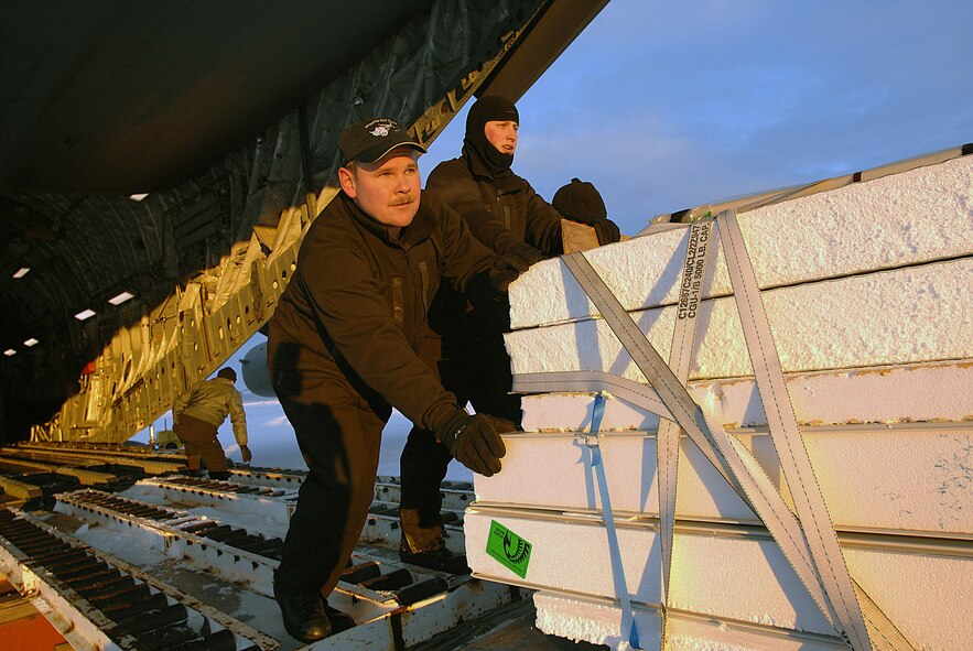 Senior Master Sgt. Lance Gustafson, left, and Senior Airman Douglas Reimer offload pallets from a C-17 Globemaster III in Antarctica  on April 17. The two loadmasters are part of a Total Force crew from the Reserve 446th Airlift Wing and the active-duty 62nd Airlift Wing. The C-17 is staging out of Christchurch, New Zealand on a final Operation Deep Freeze for the 2007-2008 season. (U.S. Air Force photo/Staff Sgt. Aaron Allmon)