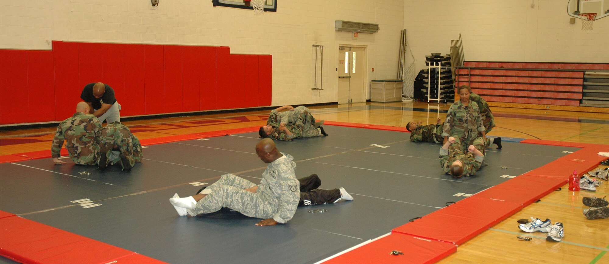 Patrolmen from the 325th Security Forces Squadron practice techniques during a self defense course at the base fitness center Friday.  Carlos Cummings, martial arts instructor and owner of Cummings Combat Sambo was teaching the course to the Airmen to teach them some hand-to-hand combat techniques that they can use on the job here and at deployed locations.  (U.S. Air Force photo/Staff Sgt. Timothy R. Capling)