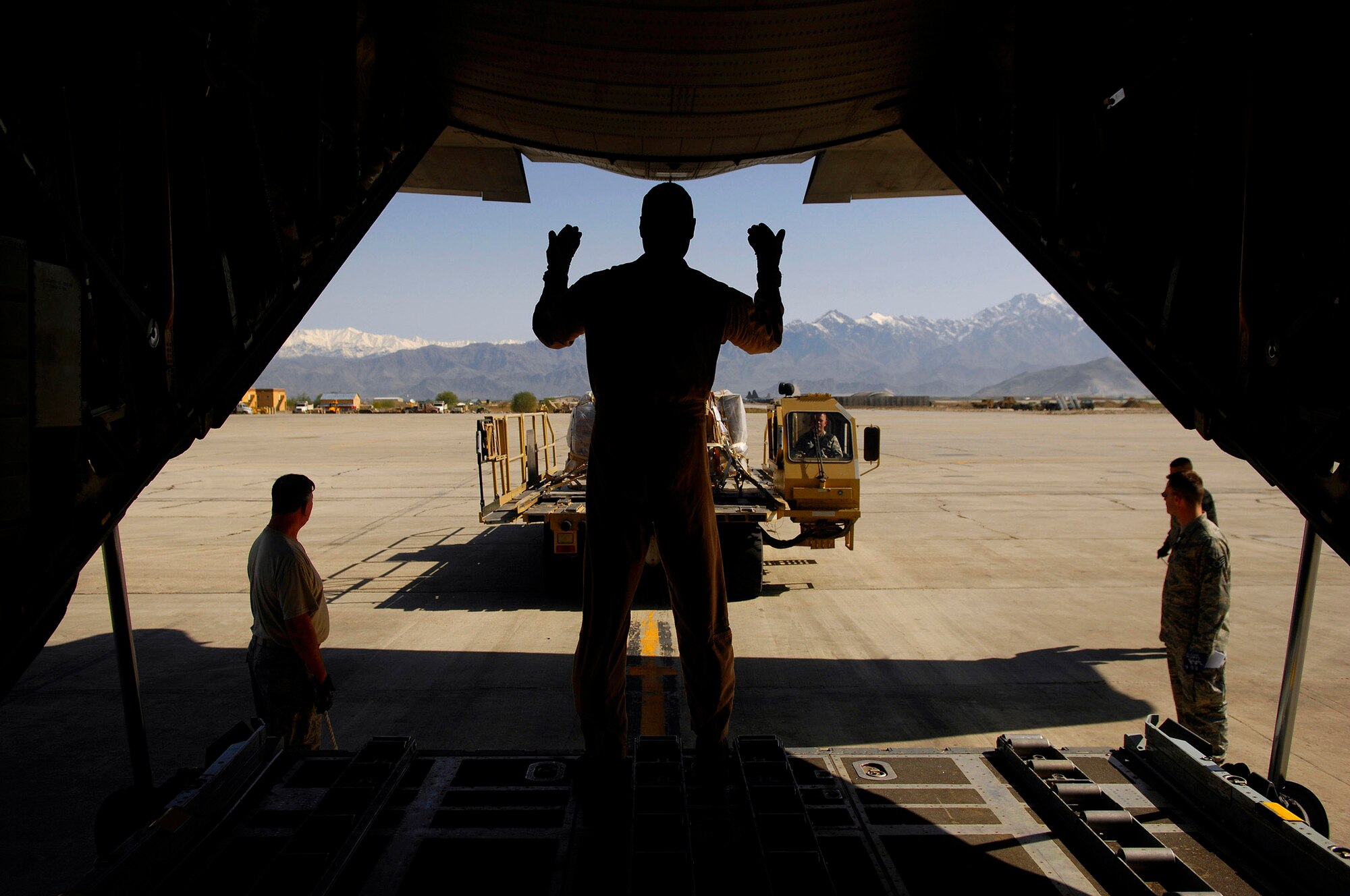 Master Sgt. Anthony Harrington directs the cargo to be loaded on a C-130 Hercules during an Operation Enduring Freedom mission April 16 from Bagram Air Base, Afghanistan. Sergeant Harrington is a loadmaster assigned to the 774th Expeditionary Airlift Squadron and deployed from the 109th Airlift Squadron from Minneapolis. (U.S. Air Force photo/Master Sgt. Andy Dunaway)