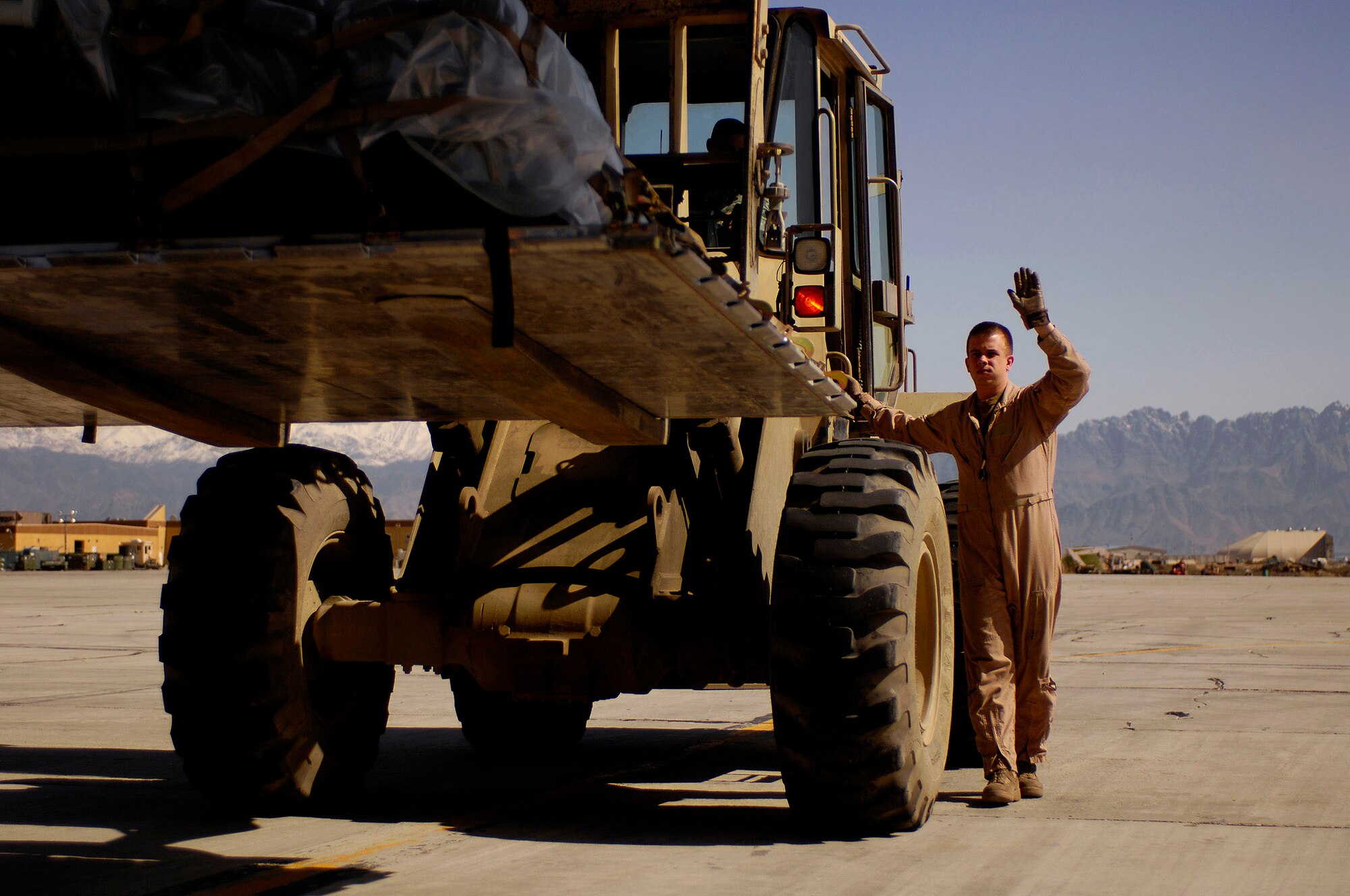 Staff Sgt. Brian Kinner directs the forklift towards the C-130 Hercules for another mission April 16 at Bagram Air Base, Afghanistan. Sergeant Kinner is a loadmaster assigned to the 774th Expeditionary Airlift Squadron and deployed from the 105th Airlift Squadron from Nashville, Tenn. (U.S. Air Force photo/Master Sgt. Andy Dunaway)

