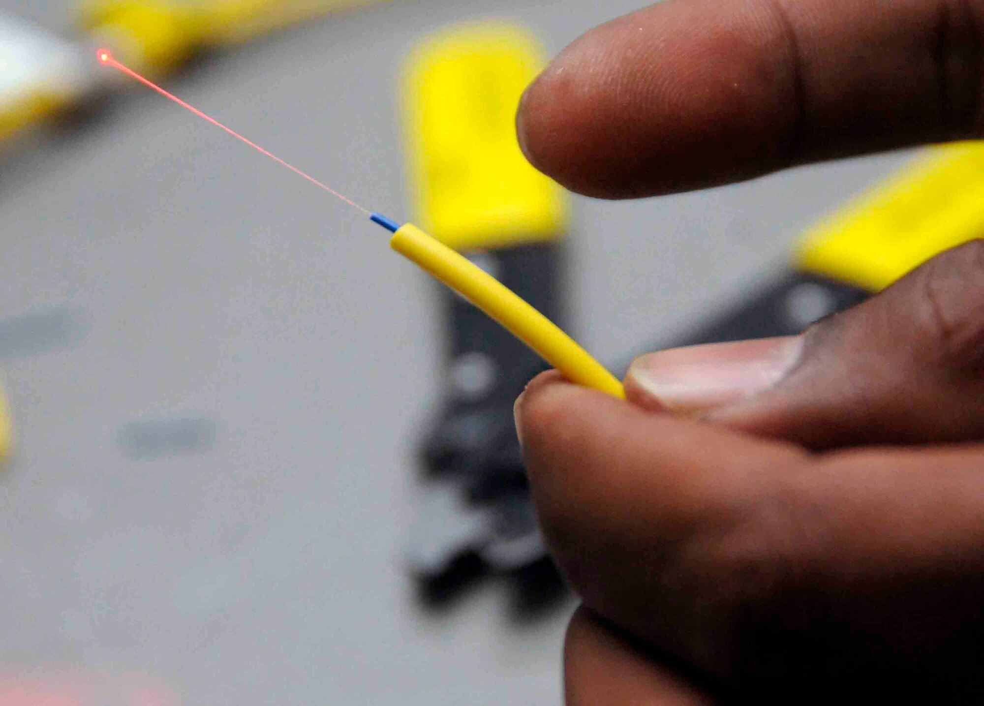 Staff Sgt. David Reyes puts a hot melt patch kit onto a single mode fiber to have communication connectivity between a switch and patch panel onto the user. A single strand of fiber can support up to 900 communication lines with the proper multiplexer. 
 (U.S. Air Force photo by Senior Airman Domonique Simmons)