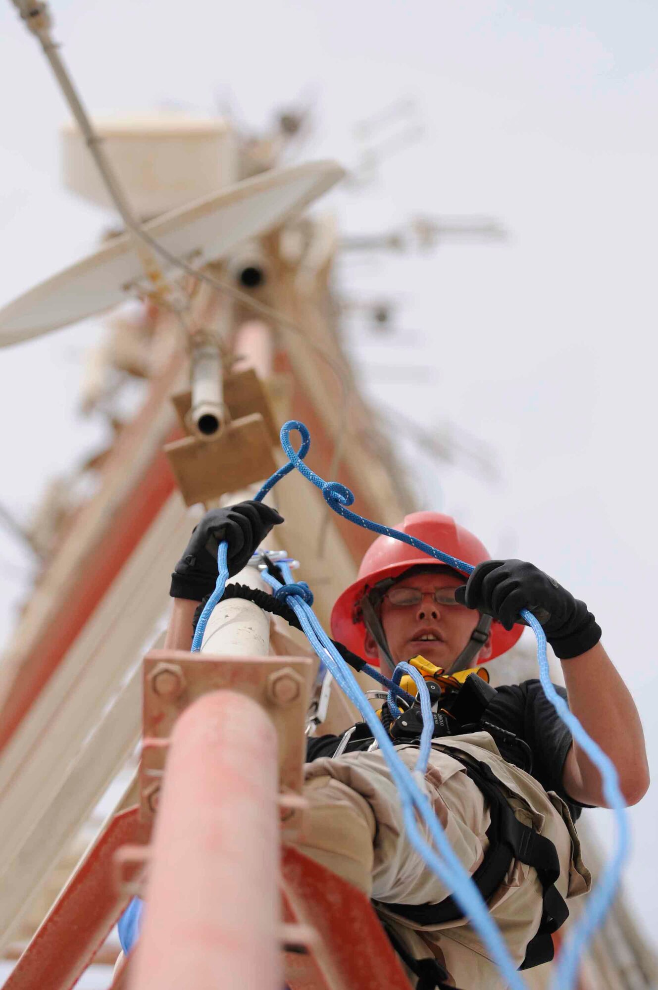 Staff Sgt. Andrew Post, 379th Expeditionary Communication Squadron Cable and Antenna team member from Kapaun Air Station, Germany, pulls up a length of repel rope to place into his rope bag. The rope must be replaced after each job to prevent excessive damage, as it is used by team members for training or tower rescue. (U.S. Air Force photo by Senior Airman Domonique Simmons)
