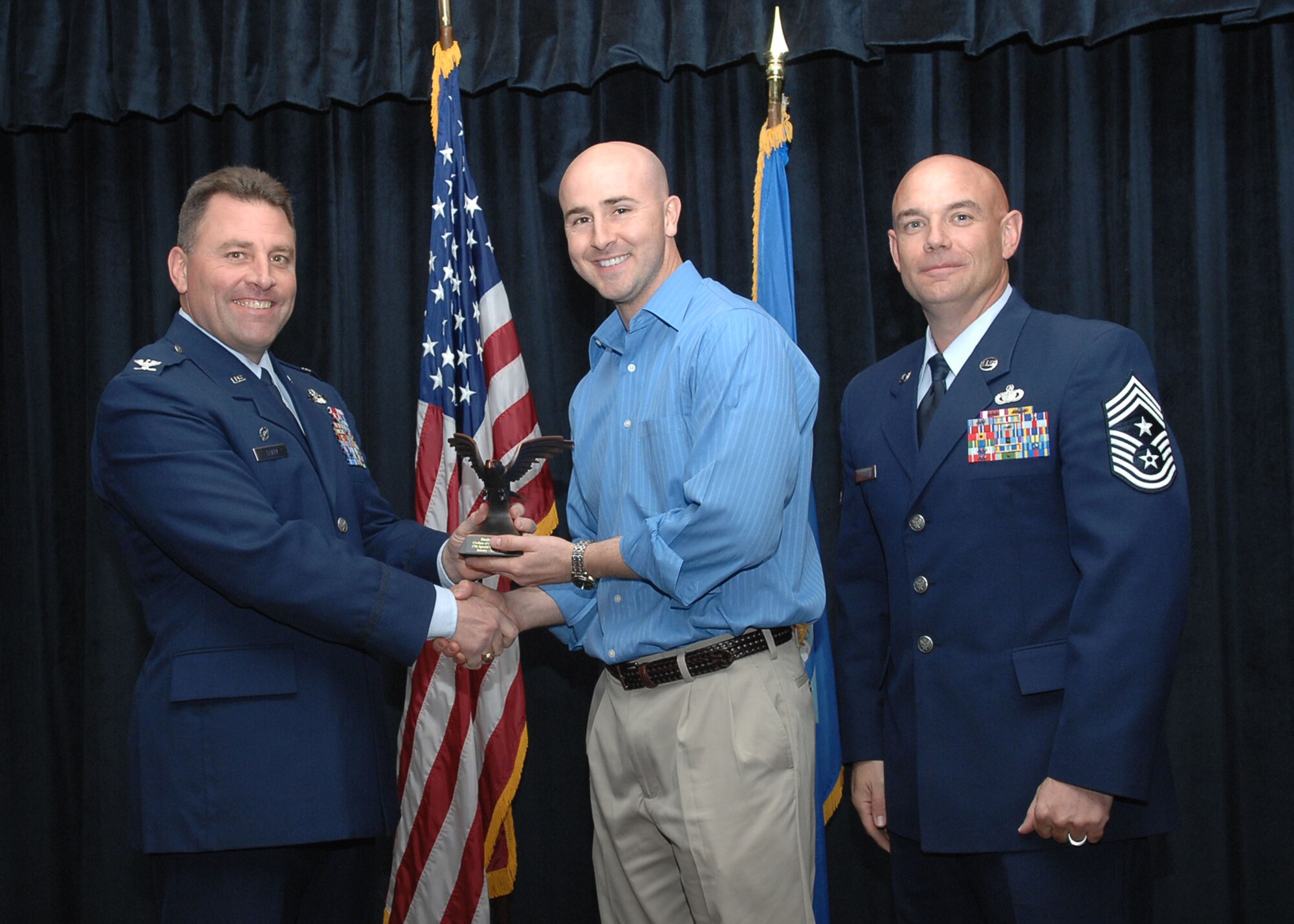 CANNON AIR FORCE BASE, N.M. - Mr. Daniel Fales, 27th Special Operations Support Squadron, receives the Civilian of the the Quarter Category II award presented by Col. Timothy Leahy, 27th Special Operations Wing commander, and Chief Master Sgt. Daniel Fischer, 27th Special Operations Wing command chief. (U.S. Air Force photo/Airman Basic Danielle Martin) 