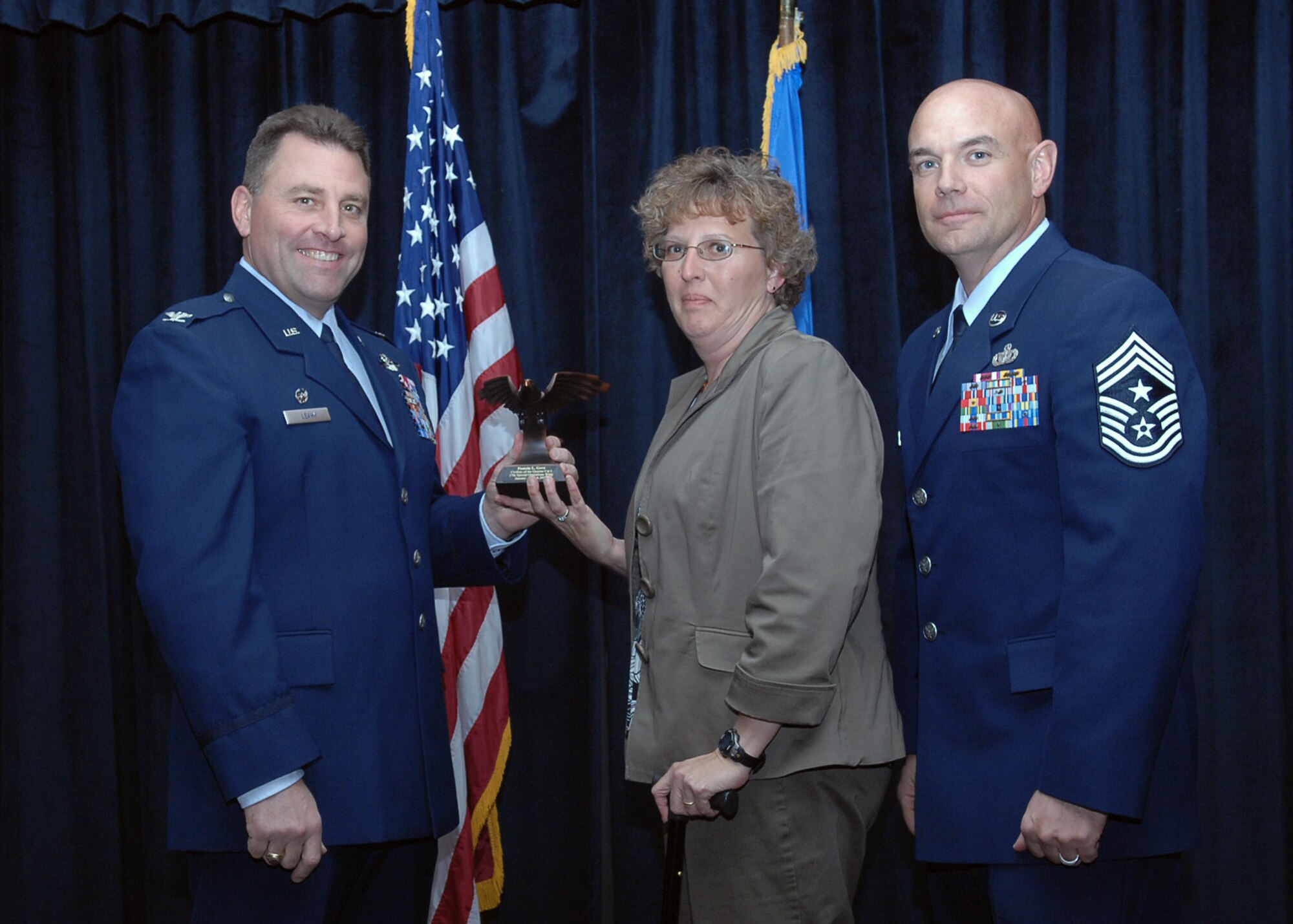 CANNON AIR FORCE BASE, N.M. - Ms. Pamela Gove, 27th Special Operations Mission Support Squadron, receives the Civilian of the the Quarter Category I award presented by Col. Timothy Leahy, 27th Special Operations Wing commander, and Chief Master Sgt. Daniel Fischer, 27th Special Operations Wing command chief. (U.S. Air Force photo/Airman Basic Danielle Martin) 