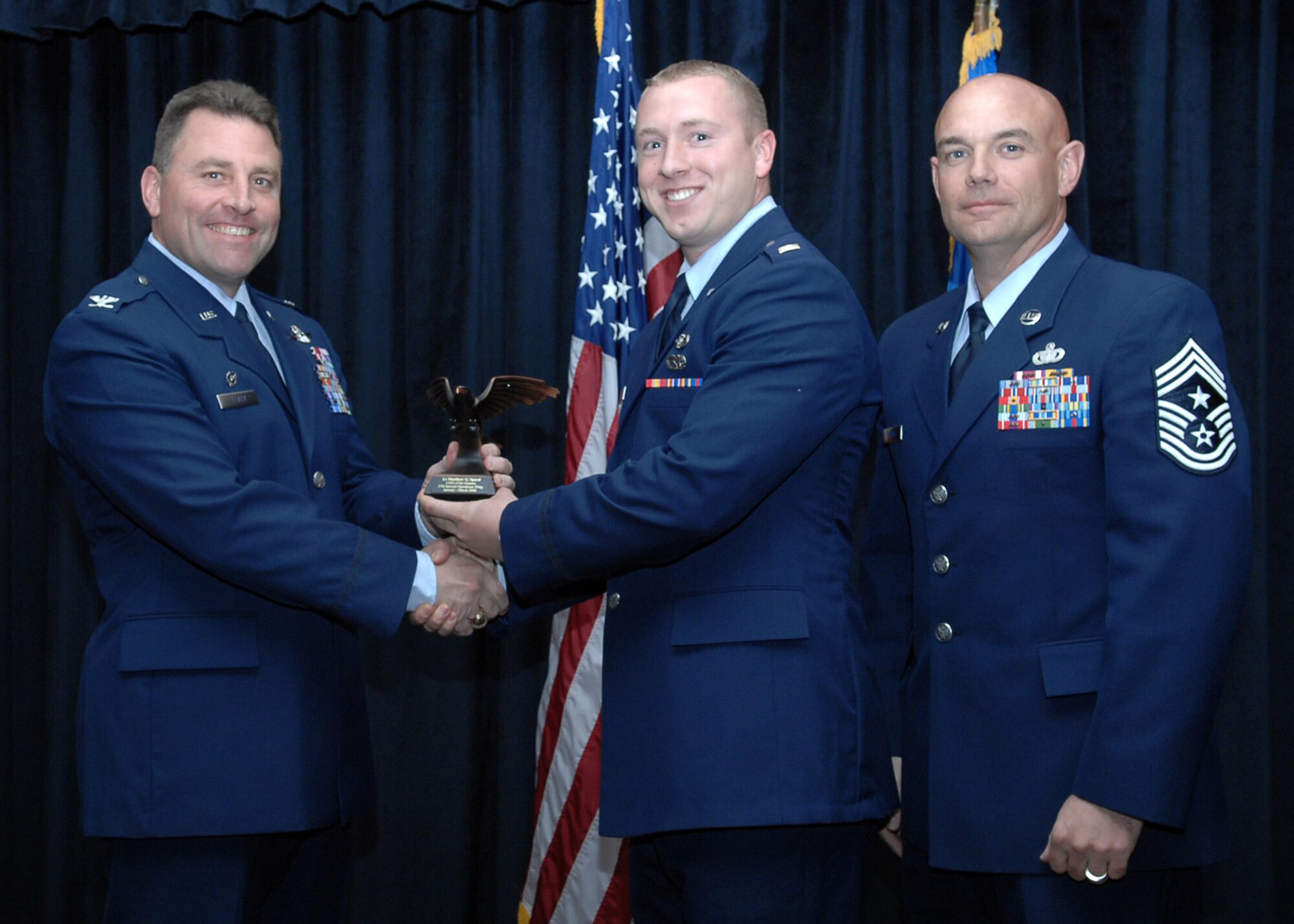 CANNON AIR FORCE BASE, N.M. - 2nd Lt. Matthew Speed, 27th Special Operations Maintenance Squadron, receives the Company Grade Officer of the Quarter award presented by Col. Timothy Leahy, 27th Special Operations Wing commander, and Chief Master Sgt. Daniel Fischer, 27th Special Operations Wing command chief. (U.S. Air Force photo/Airman Basic Danielle Martin) 