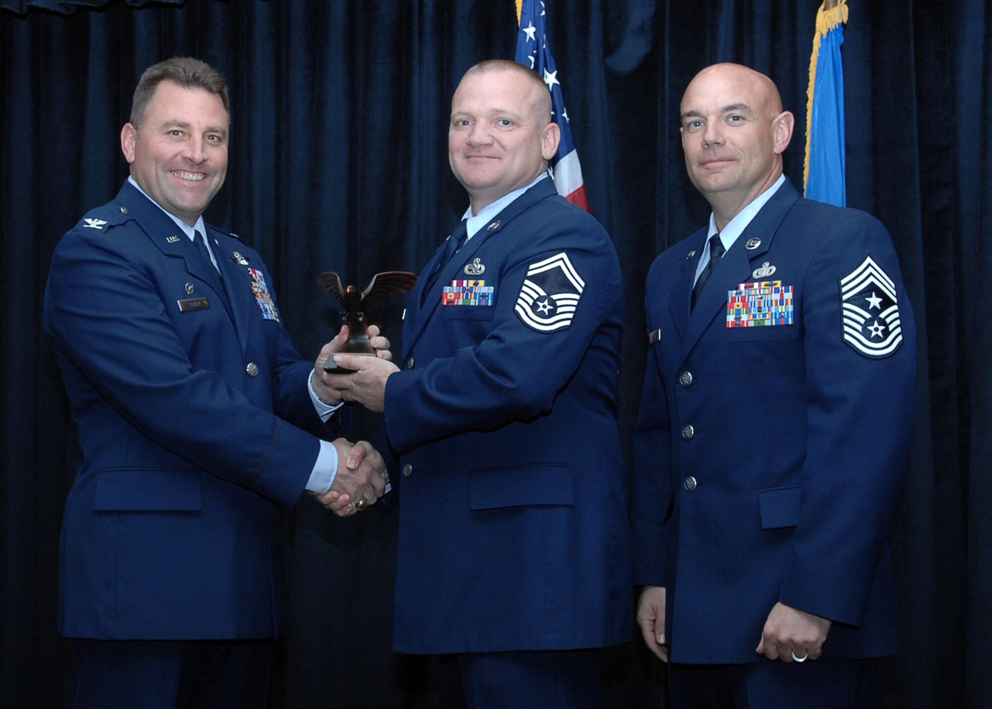 CANNON AIR FORCE BASE, N.M. - Senior Master Sgt. John Crawley, 27th Special Operations Maintenance Squadron, receives the Senior Non-Commisioned Officer of the Quarter award presented by Col. Timothy Leahy, 27th Special Operations Wing commander, and Chief Master Sgt. Daniel Fischer, 27th Special Operations Wing command chief. (U.S. Air Force photo/Airman Basic Danielle Martin) 