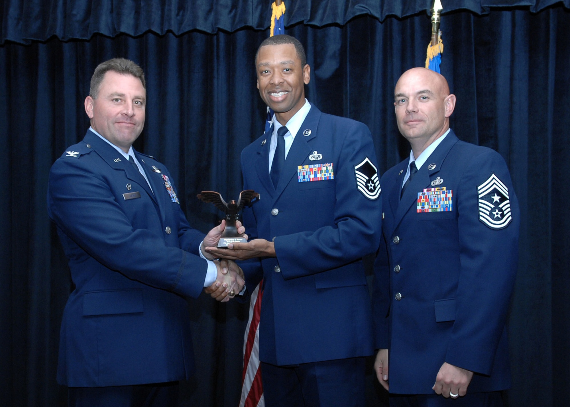 CANNON AIR FORCE BASE, N.M. - Master Sgt. Rodney Barner, 27th Special Operations Services Squadron, then technical sergeant,  receives the Non-Commisioned Officer of the Quarter award presented by Col. Timothy Leahy, 27th Special Operations Wing commander, and Chief Master Sgt. Daniel Fischer, 27th Special Operations Wing command chief. (U.S. Air Force photo/Airman Basic Danielle Martin) 