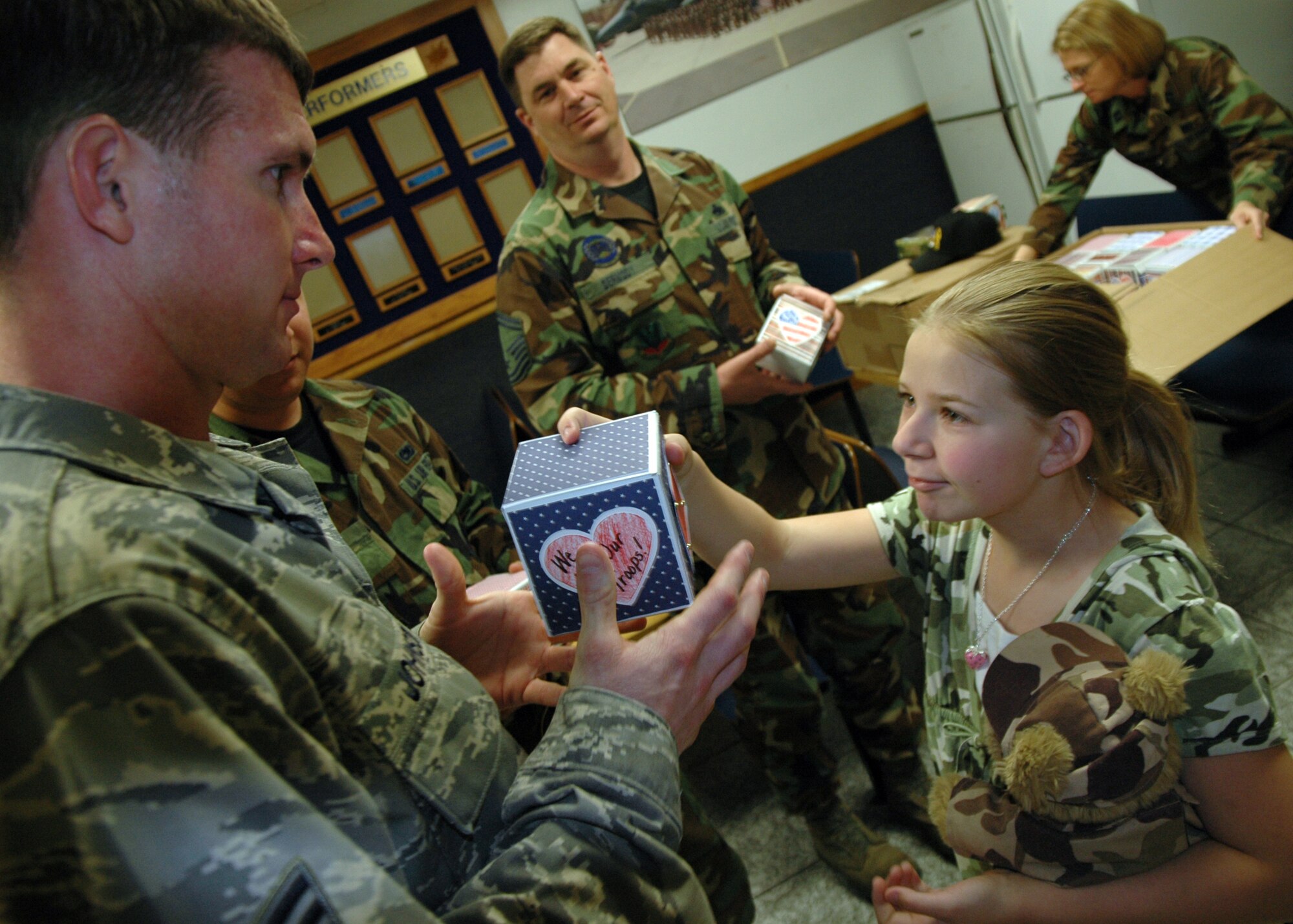 EGLIN AIR FORCE BASE, Fla. -- Bailey Reese, founder and president of Hero Hugs, hands one of more than 200 care boxes full of candy, cookies and a hand written card to Staff Sgt. Robert Johnson a crew chief from the 58th Aircraft Maintenance Unit, during a visit to the 33d Fighter Wing April 16. Hero Hugs is a nonprofit organization that delivers care packages to Airmen, Soldiers, Sailors and Marines all across the world. To learn more about Bailey and Hero Hugs go to www.herohugs.org. (U.S. Air Force photo by Staff Sgt. Bryan Franks) 