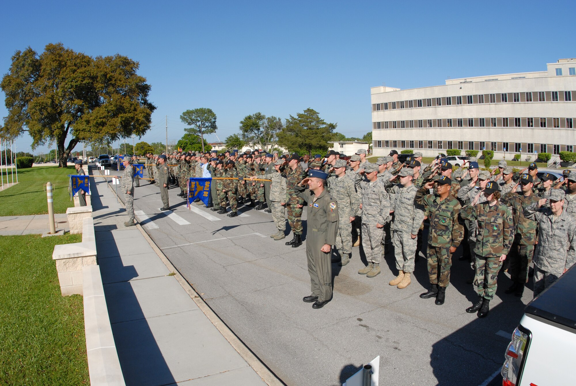 Three flights representing the three squadrons of the 53d Electronic Warfare Group salute in unison during the retreat ceremony April 17 at Eglin Air Force Base.  The ceremony was performed solely by the 53d EWG and its squadrons – the 16th Electronic Warfare Squadron, 36th Electronic Warfare Squadron and the 68th Electronic Warfare Squadron. This is the last base retreat ceremony the EWG will perform as part of the 53d Wing.  By October, the group will transition to Air Force Cyber Command.  Photo by Staff Sgt. Samuel King Jr.