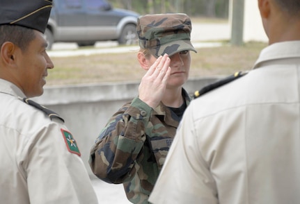 SOTO CANO AIR BASE, Honduras--Air Force Staff Sgt. Sonja Berry salutes a Honduran officer during an information exchange at the Honduran Military Training Academy in Tegucigalpa, Honduras April 16. During her visit, Sergeant Berry got a glimpse into the daily life of academy cadets preparing as future leaders of the Honduran Army and took a great interest into the training female cadets receive at the academy. Females were first allowed into the academy in 1998.  (U.S. Air Force photo by Tech. Sgt. William Farrow) 