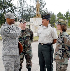 SOTO CANO AIR BASE, Honduras--Air Force Senior Master Sgt. Les Bramlett, 2nd Lt. Zack Kalinauskis and Maj. Tiffany Morgan visit with Lt. Col. Raynel Funes, Honduran Military Training Academy deputy director, during an information exchange and tour of the Honduran Military Training Academy in Tegucigalpa, Honduras April 16.  (U.S. Air Force photo by Tech. Sgt. William Farrow) 