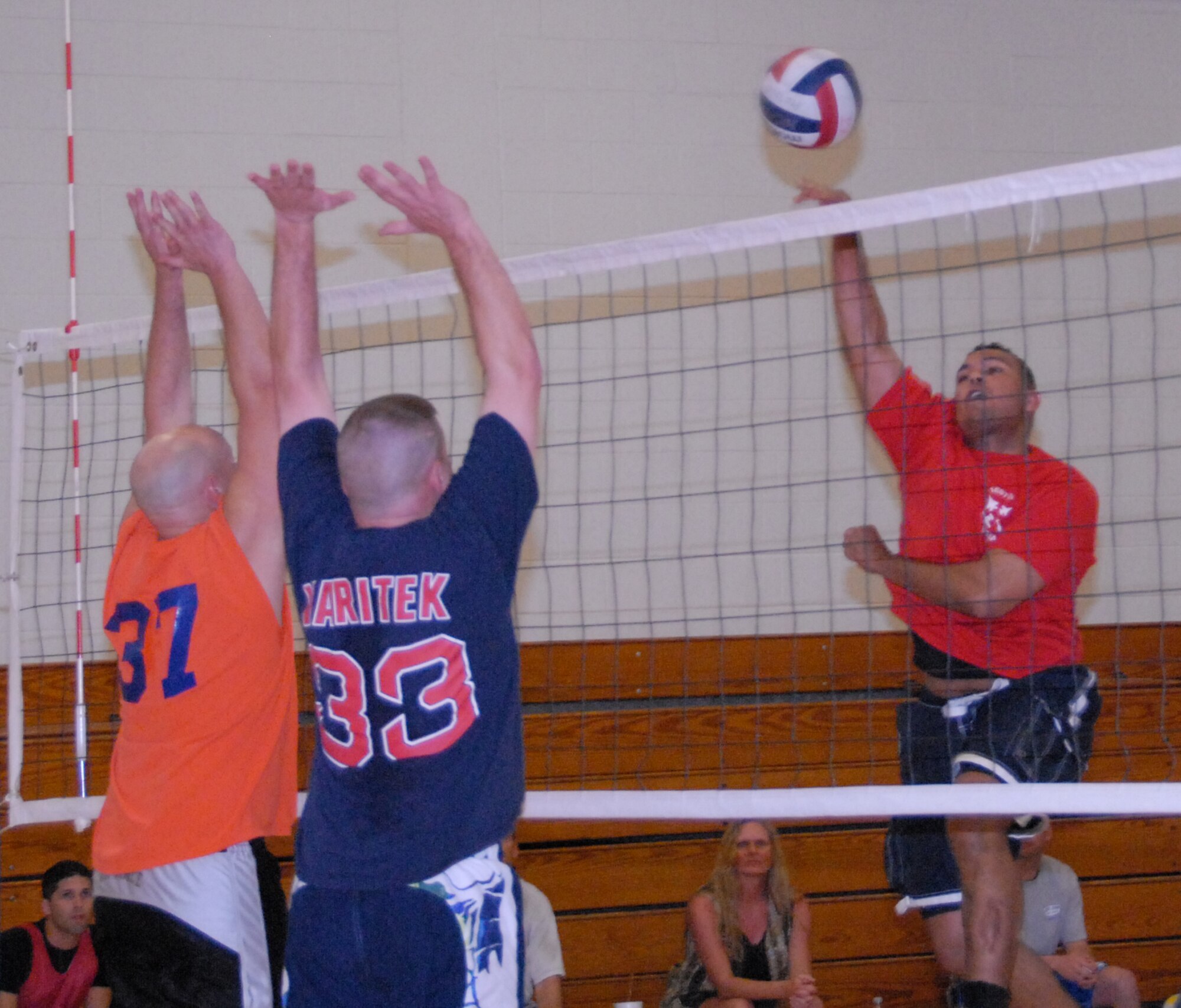 Antone Smith, 53d Wing, spikes the ball past 96th Communications Squadron defenders April 17 during an intramural playoff game at Eglin Air Force Base, Fla.  The 53d lost a close match to go 9-5 on the year.  The COMM team moved on to play the 33rd Maintenance Squadron in the finals.  Photo by Staff Sgt. Samuel King Jr.