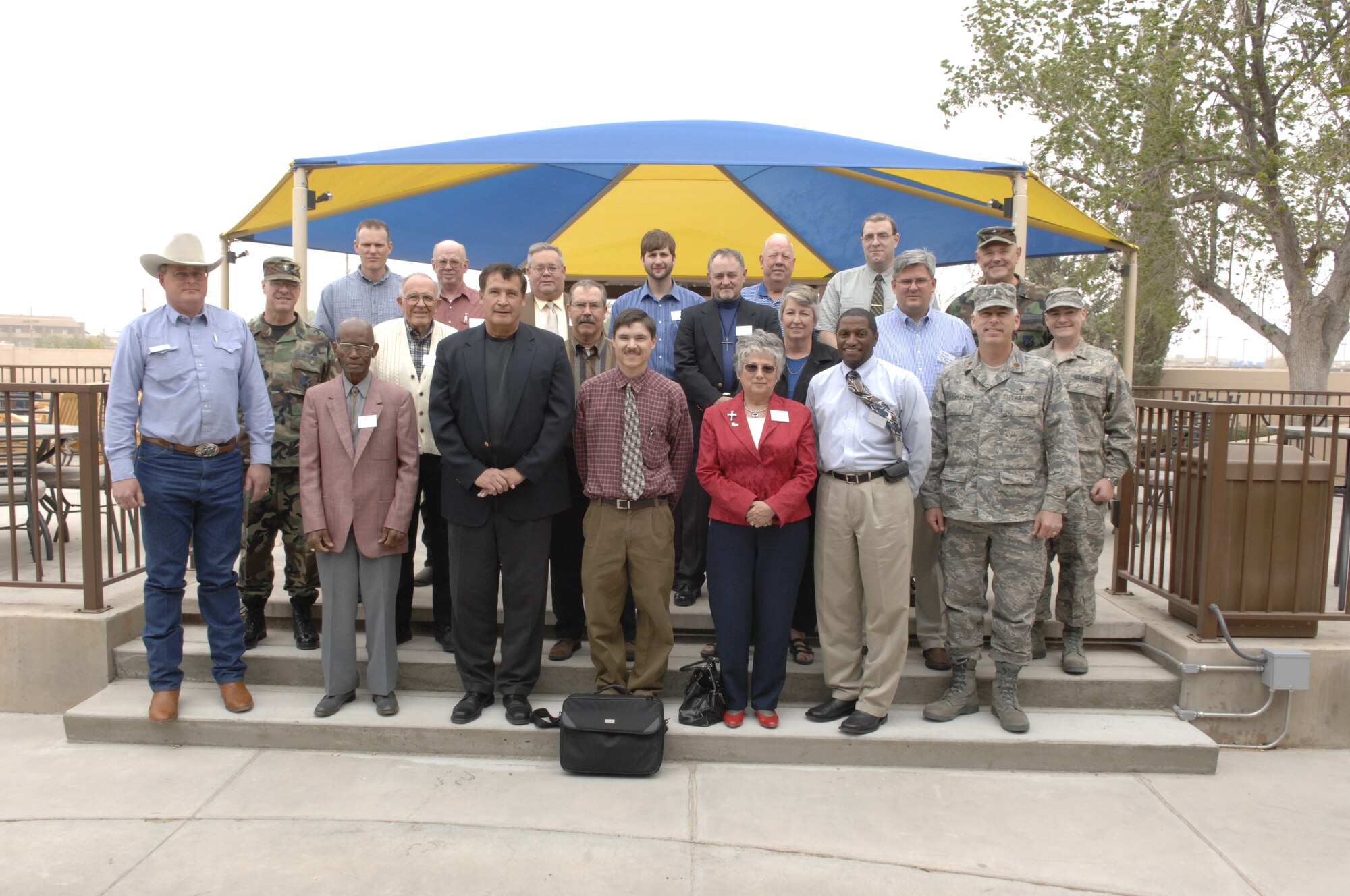 HOLLOMAN AIR FORCE BASE, N.M. -- Members of the clergy and Clergy Day participants pose after lunch at the Stealth Landing Officers’ Club here April 8.  Twenty members of the clergy from in and around the local area attended the day aimed at promoting teamwork and working toward the common goal of bringing the base and the community closer together. (U.S. Air Force photo/Airman 1st Class Rachel Kocin)