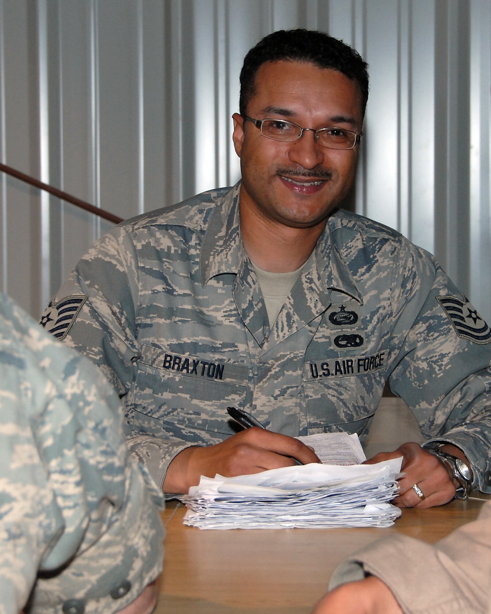 SOUTHWEST ASIA -- Technical Sgt. Carl Braxton, 386th Expeditionary Mission Support Group NCO in charge of customer service for the Personnel Support for Contingency Operations team, is responsible for ensuring personnel deploying into and out of Iraq and the Persian Gulf Region are squared away and accounted for. (U.S. Air Force photo/Tech. Sgt. Michael O'Connor)