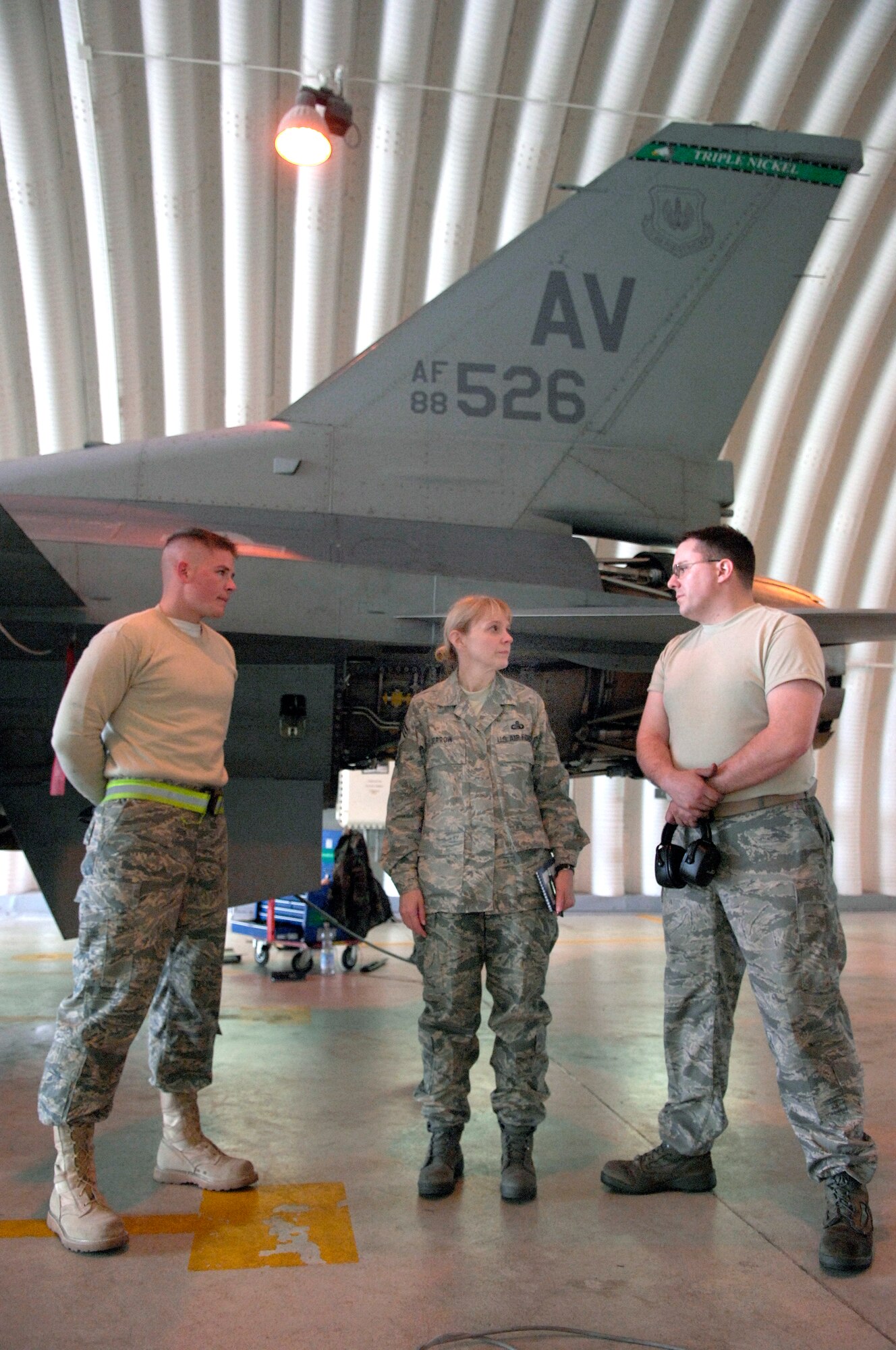 AVIANO AIR BASE, Italy -- United States Air Forces in Europe Command Chief Master Sgt. Pamela Derrow talks with Airman 1st Class Shawn Edwards (left) and Staff Sgt Eric Breault about the complexities of engine repair at Aviano Air Base, April 15, 2008.  CMSgt Derrow is visiting bases throughout USAFE along with Gen. Brady to answer any questions or concerns Airmen might have.  (U.S. Air Force photo/Senior Airman Michael S. Dorus) (Released)