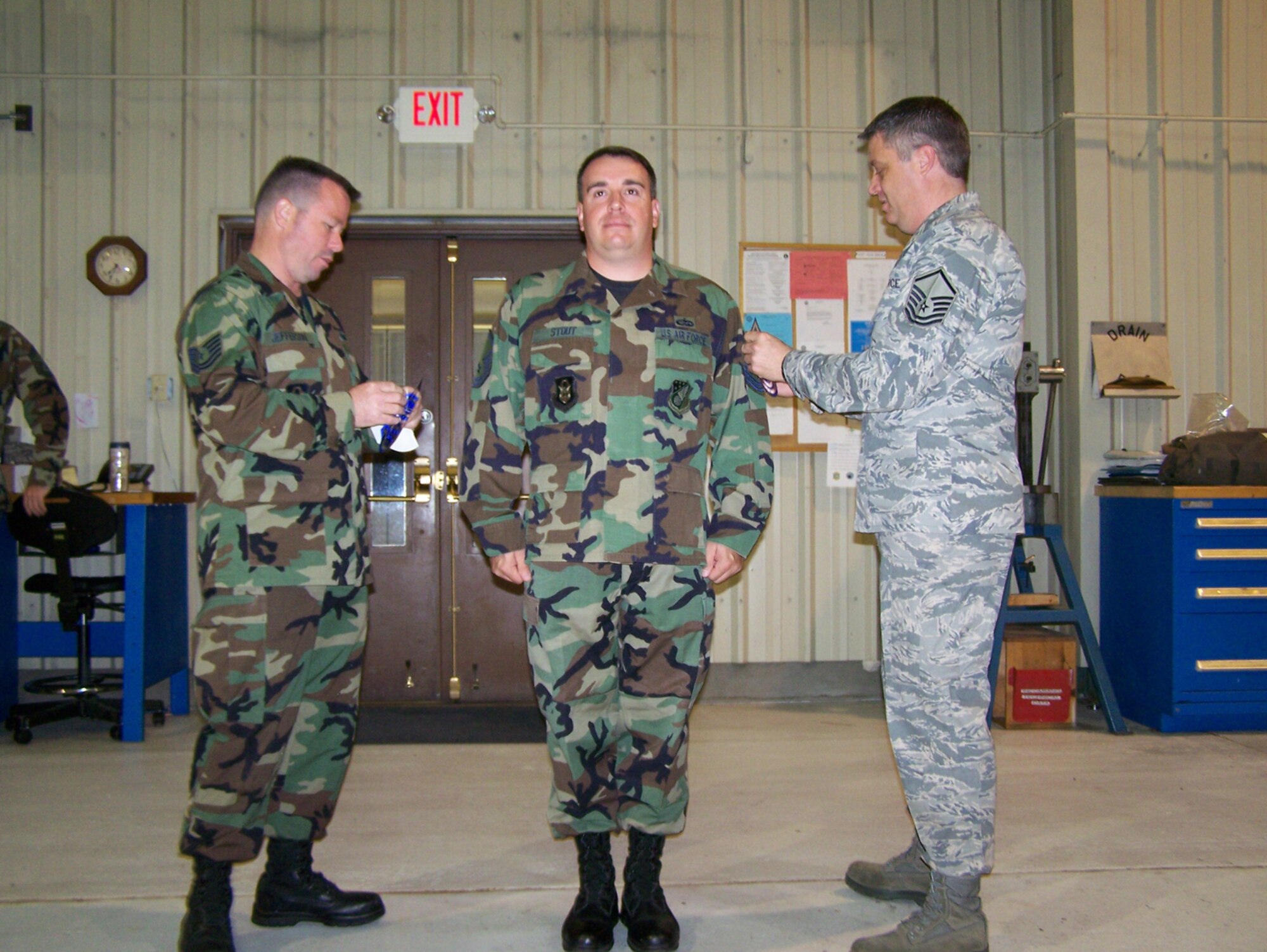 SEYMOUR JOHNSON AIR FORCE BASE, N.C. -- Master Sgt. Michael Stout (center) receives his senior non-commissioned officer stripes from Master Sgt. Shawn Futrell (right) and Tech. Sgt. Kenneth Jefferson. Sergeant Stout is a KC-135R crew chief with the 916th Aircraft Maintenance Squadron.