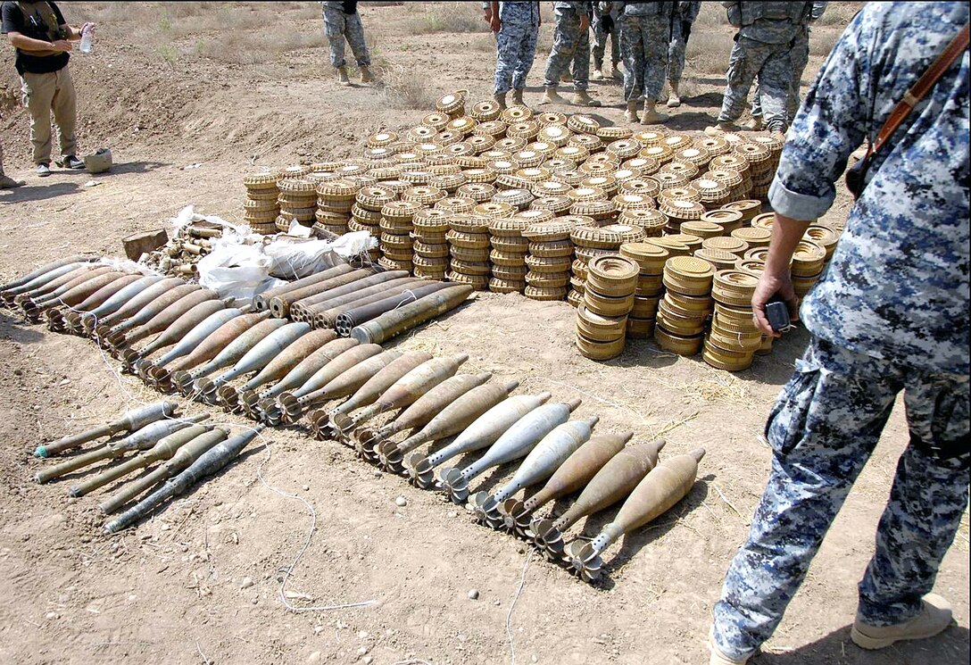 Iraqi National Police discover a weapons cache near a checkpoint outside Abu Thayla, Iraq, April 13, 2008. U.S. Army soldiers assigned to the 3rd Infantry Division's 3rd Squadron, 1st Cavalry, 3rd Brigade Combat Team helped transport the seized weapons to Command Outpost Cashe.