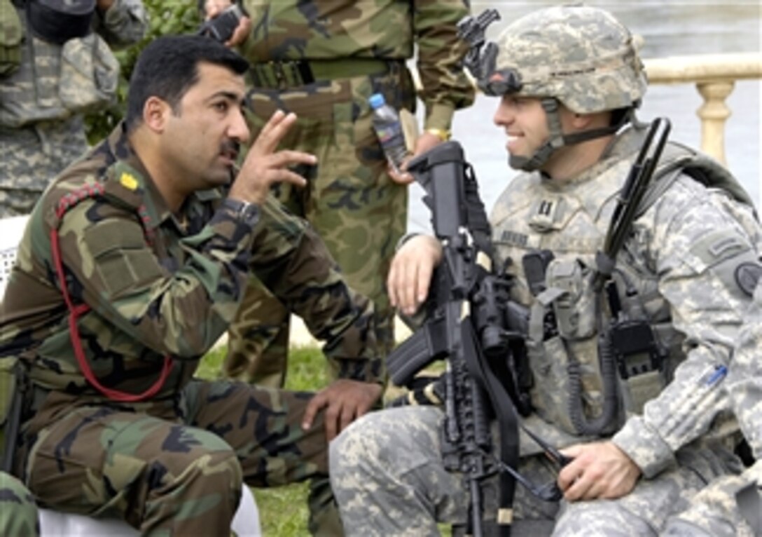 U.S. Army Capt. Hunter Bowers, right, speaks with Iraqi Army Col. Abdol Amir in Mosul, Iraq, April 10, 2008.
