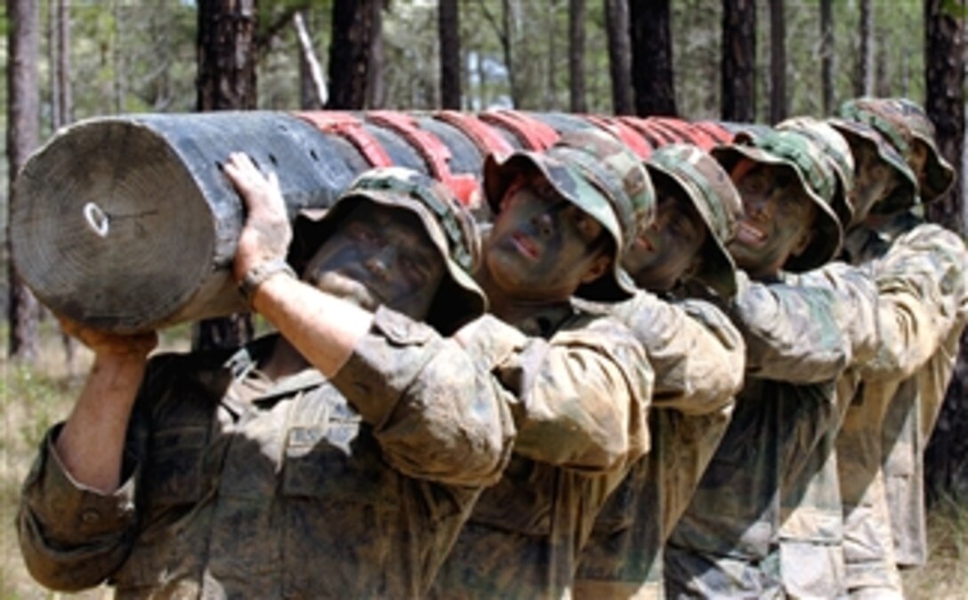 U. S. Air Force students maneuver a log during the "monster mash" event during a Combat Control School exercise on Fort Bragg, N.C., April 9, 2008. The monster mash is an endurance event to build stamina and encourage teamwork. 
