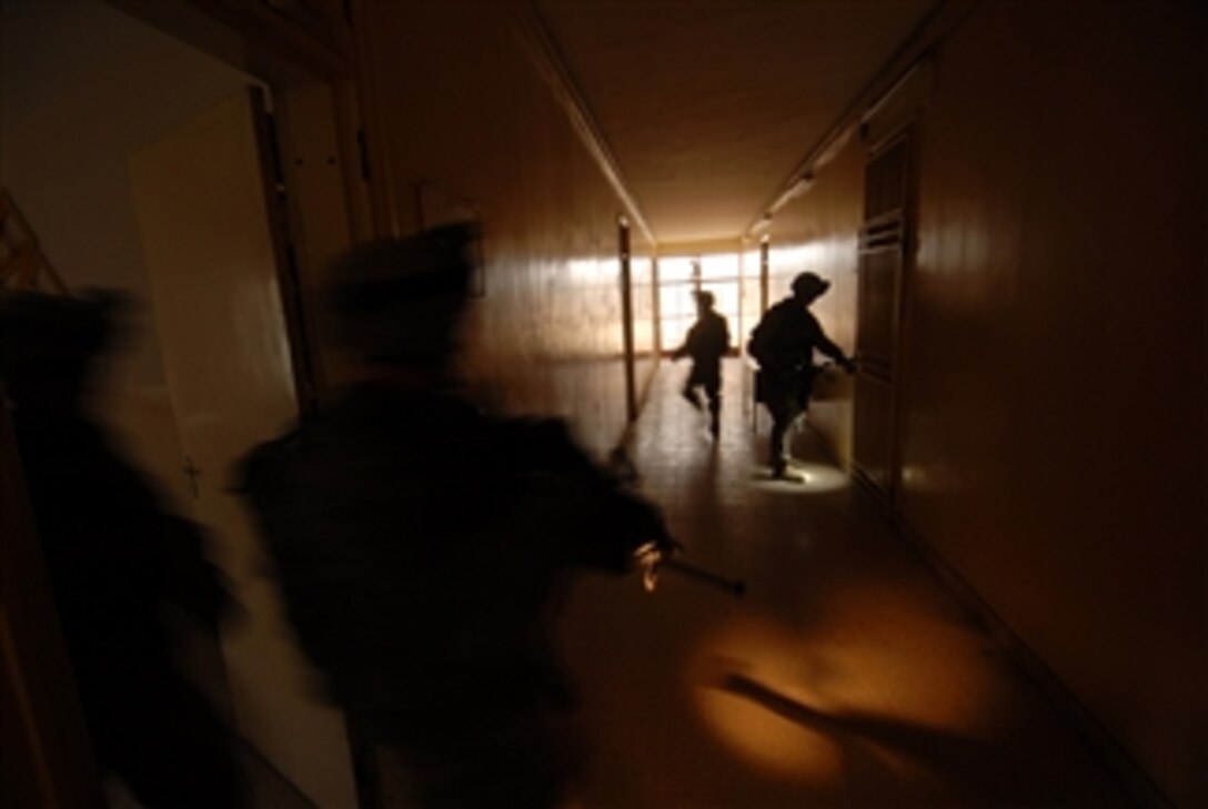 U.S. Army soldiers from Delta Company, 2nd Squadron, 2nd Stryker Cavalry Regiment conduct a search for weapons caches and insurgent activity during an operation in the Al Rashid district of Baghdad, Iraq, on April 16, 2008.  