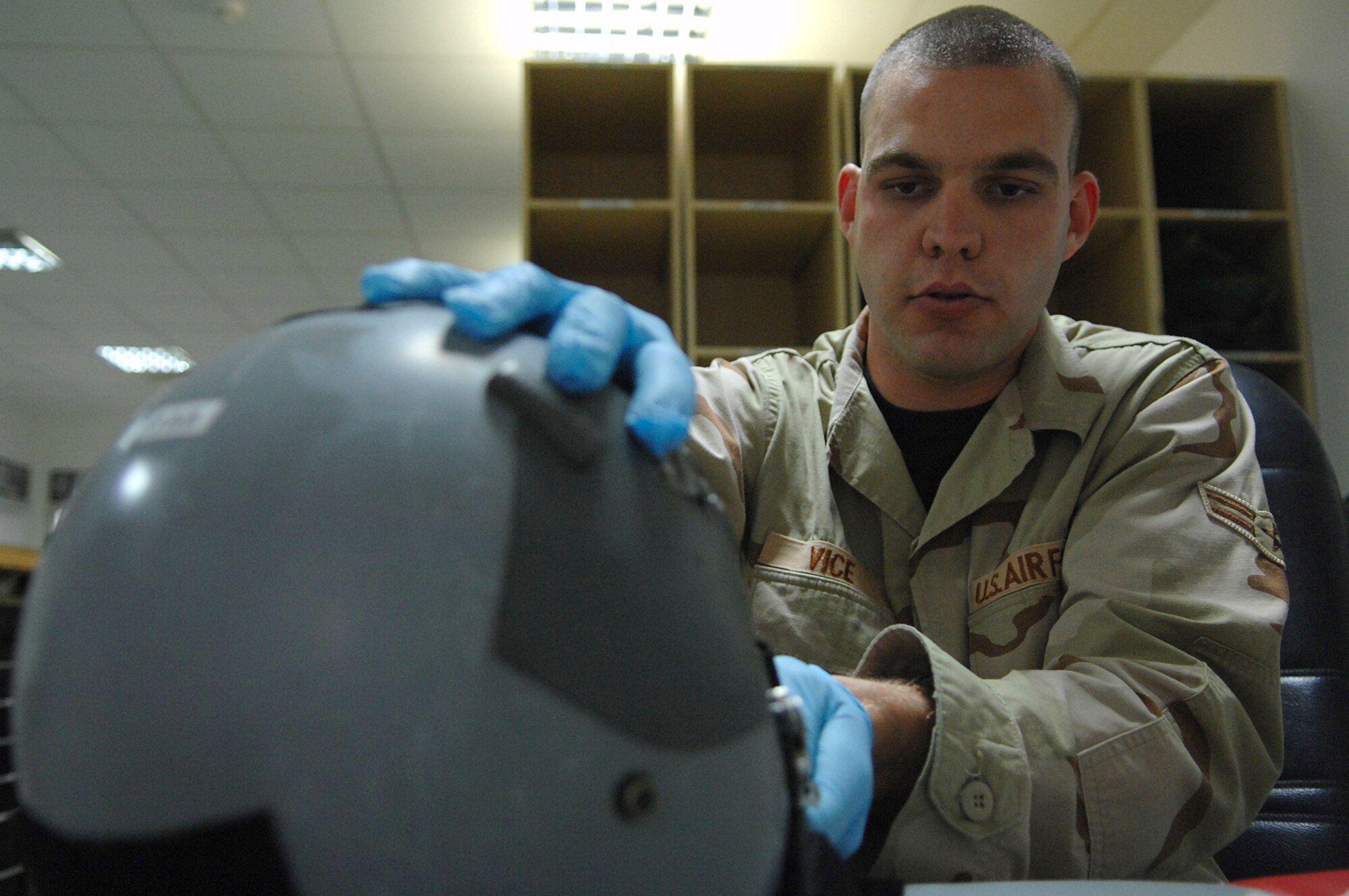 BALAD AIR BASE, Iraq -- Airman 1st Class John Vice, a 777th Expeditionary Airlift Squadron aircrew flight equipment technician, performs a 30-day inspection on a C-130 Hercules aircrew helmet here, April 16. The helmet provides wearers with head and eye protection and helps air crew members communicate with each other. Airman Vice is deployed from Little Rock Air Force Base, Ark. (U.S. Air Force photo/ Senior Airman Julianne Showalter) 