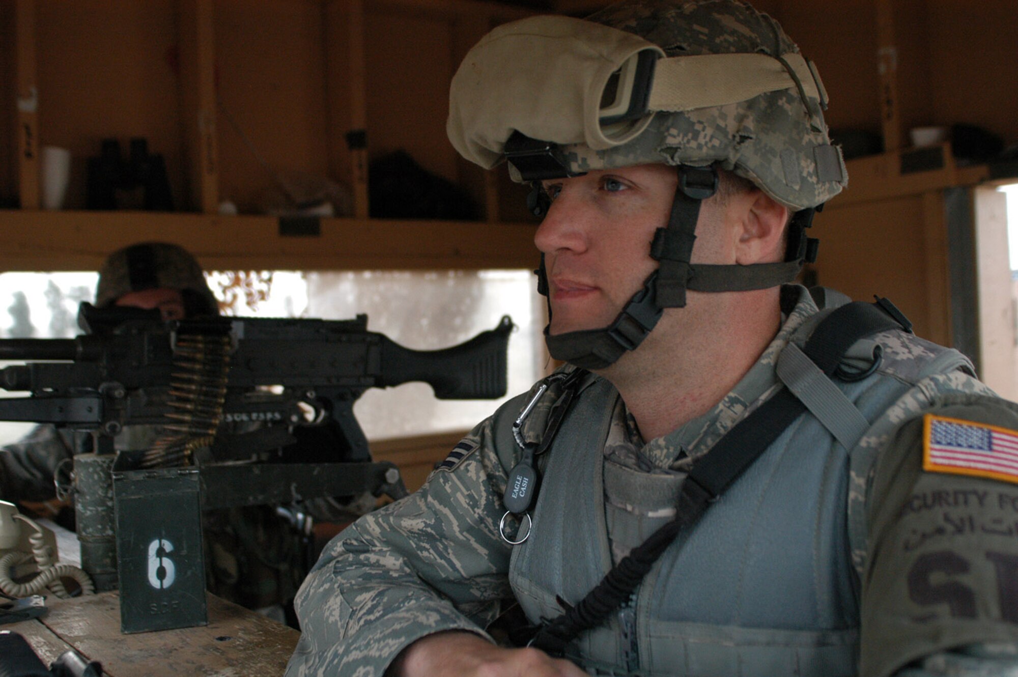 Senior Airman Anson Pryde, 506th Expeditionary Security Forces Squadron, pays close attention to his surroundings during a recent shift in one of Kirkuk's many guard towers. While typical perceptions associated with the Air Force in combat might involve aircraft dropping bombs on targets, the several hundred security forces Airmen deployed here are proving these stereotypes outdated. The Air Force’s main mission at Kirkuk is not to fly daily combat sorties, but to maintain the security of the base for the more than 5,000 personnel who operate out of here. (U.S. Air Force photo by Master Sgt. Dale Canofari)  