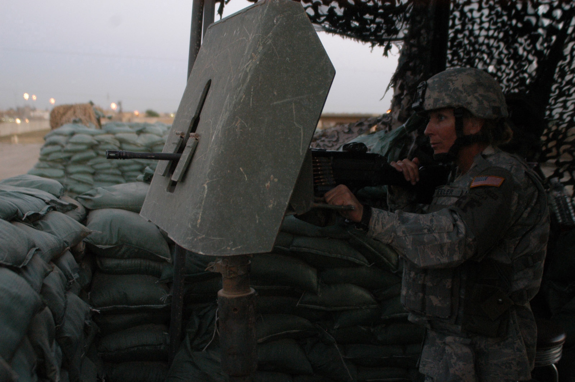 Tech. Sgt. Kelly Beeler, 506th Expeditionary Security Forces Squadron, stands post during a recent shift in one of Kirkuk's many guard towers. While typical perceptions associated with the Air Force in combat might involve aircraft dropping bombs on targets, the several hundred security forces Airmen deployed here are proving these stereotypes outdated. The Air Force’s main mission at Kirkuk is not to fly daily combat sorties, but to maintain the security of the base for the more than 5,000 personnel who operate out of here. (U.S. Air Force photo by Master Sgt. Dale Canofari)