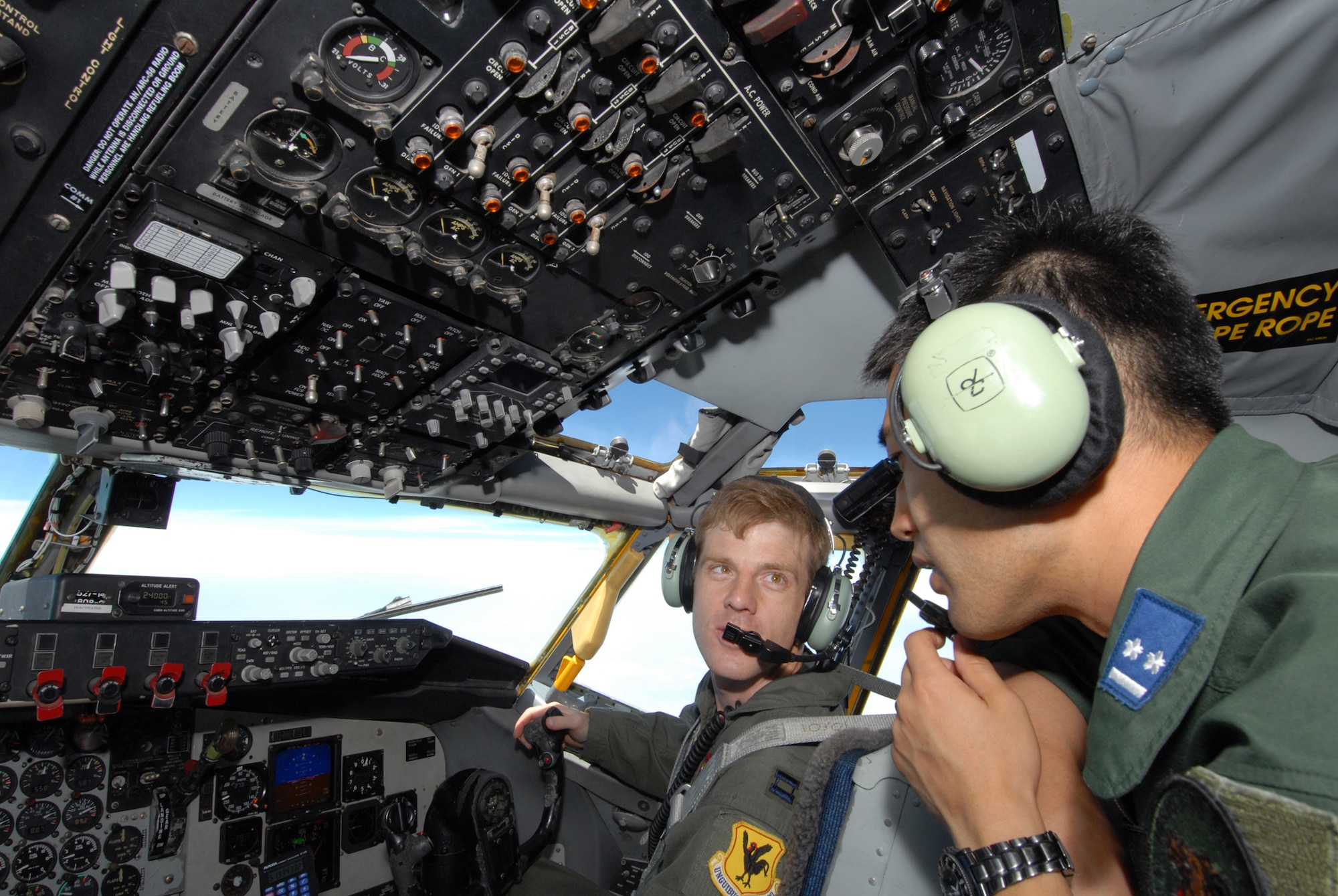 Capt. Scott Karl, 909th Air Refueling Squadron, explains to Daisaku Mieda, Japan Air Self Defense Force, the procedures for piloting the refueling jet during training at Kadena Air Base, Japan. The training was conducted to familiarize JASDF members with U.S. Air Force refueling procedures. (U.S.photo/Staff Sergeant Darnell T. Cannady)