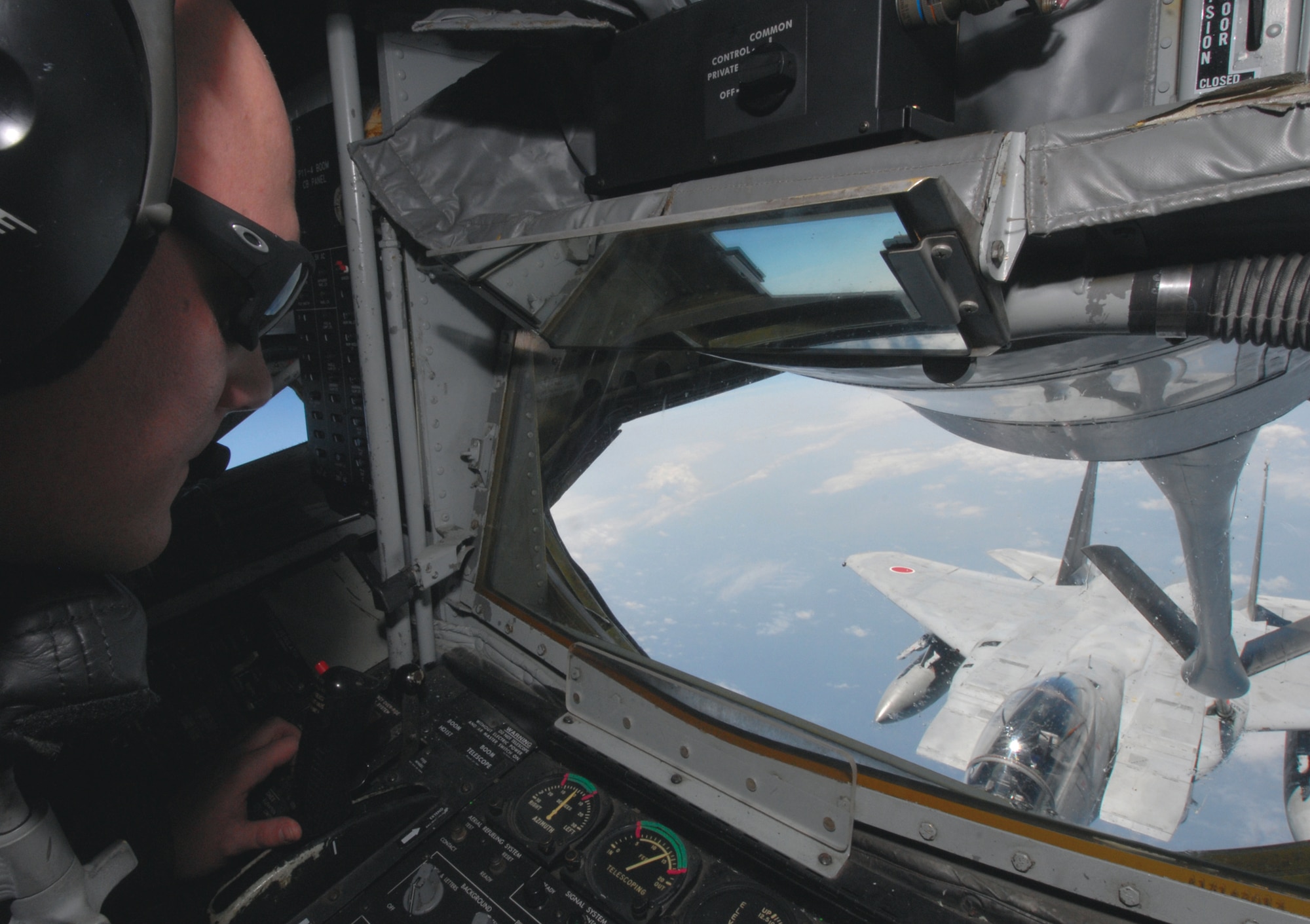 Senior Airman Christopher Pedersen, 909th Air Refueling Squadron, uses the boom to refuel a Japan Air Self Defense Force F-15 during training at Kadena Air Base, Japan. The training was conducted to familiarize JASDF members with U.S. Air Force refueling procedures. (U.S.photo/Staff Sergeant Darnell T. Cannady)