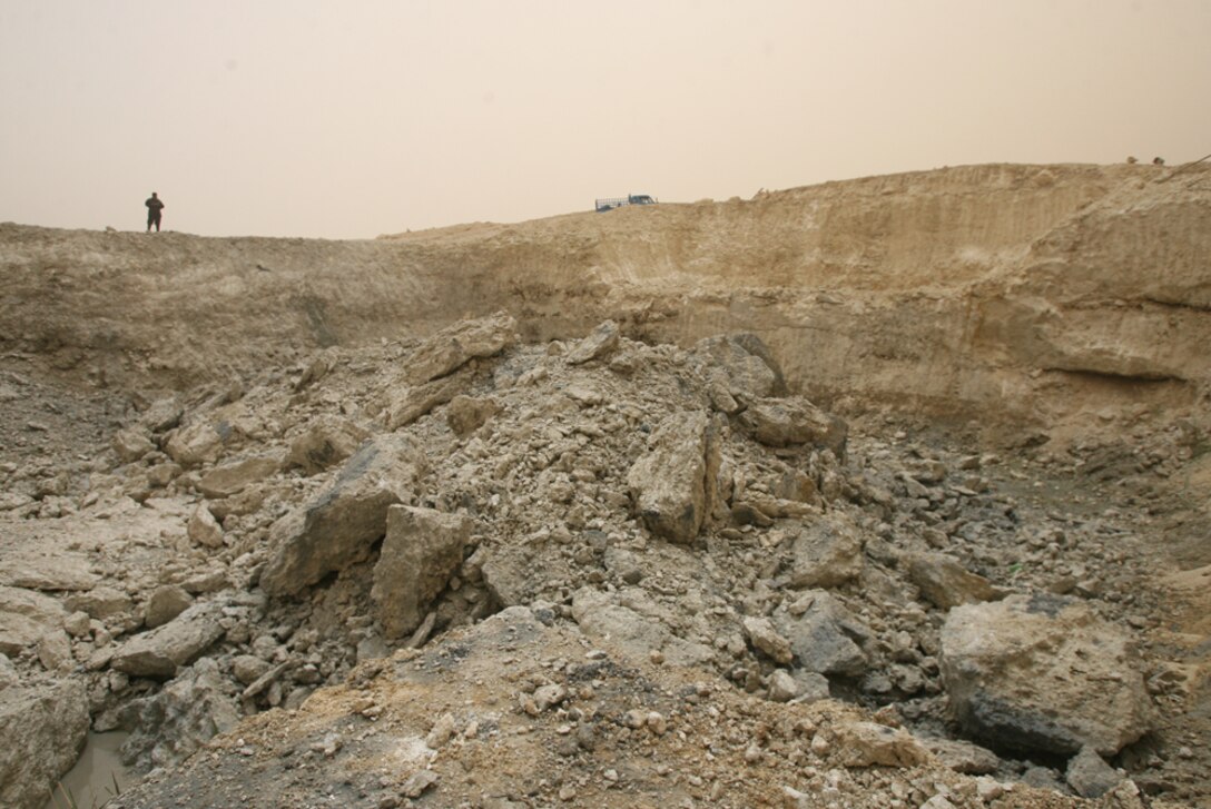 The aftermath of the explosion of 265 Bangalore Torpedoes used by Company A, 3rd Combat Engineer Battalion, Regimental Combat Team 5, Sunday to break up a bed of limestone for Iraqi contractors. The Iraqi contractors are building a cooling pond for the generators at the Tahadi power plant in Tahadi, Iraq. Once the project is complete, the power plant will be able to produce more power to the residents of Al Anbar province.