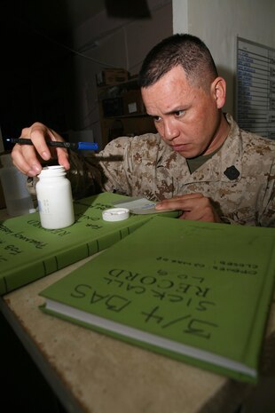 Petty Officer 3rd Class Douglas H. Mancia, hospital corpsman, 3rd Battalion, 4th Marine Regiment, Regimental Combat Team 5, from Southgate, Calif., fills a prescription for a patient at the Battalion Aid Station at Camp Hit, Iraq, April 22. Corpsmen with 3rd Bn., 4th Marine Regiment, have had an increase in responsibility because they are spread throughout the area of operations Hit and Haditha, Iraq. The Battalion Aid Station aboard Camp Hit alone sees about 12 people on a daily basis.