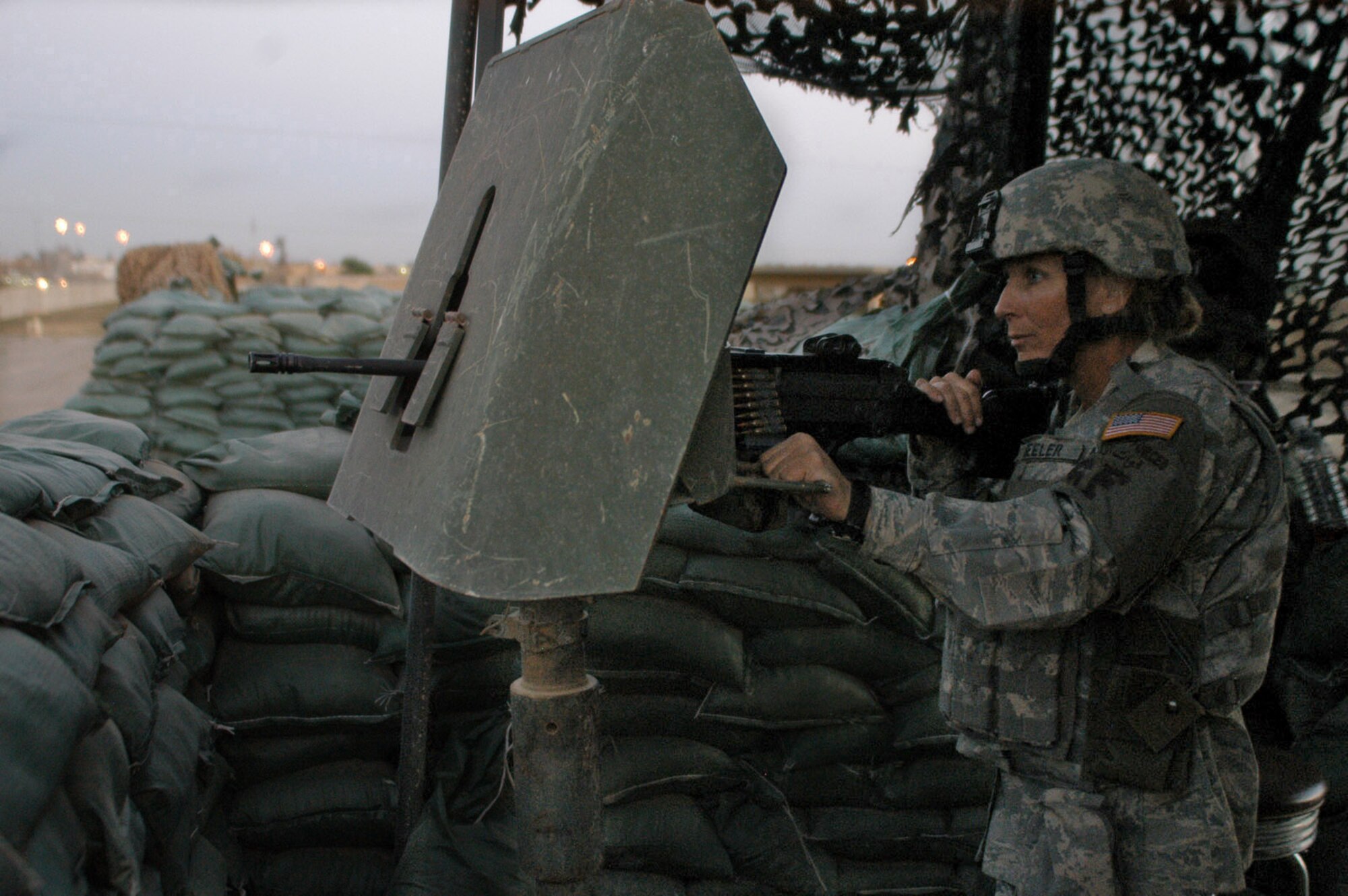 Tech. Sgt. Kelly Beeler, 506th Expeditionary Security Forces Squadron at Kirkuk Regional Air Base, Iraq, stands post in one of the base's many guard towers. While typical perceptions associated with the Air Force in combat might involve aircraft dropping bombs on targets, the several hundred security forces Airmen deployed here are proving these stereotypes outdated.  (U.S. Air Force photo/Master Sgt. Dale Canofari) 