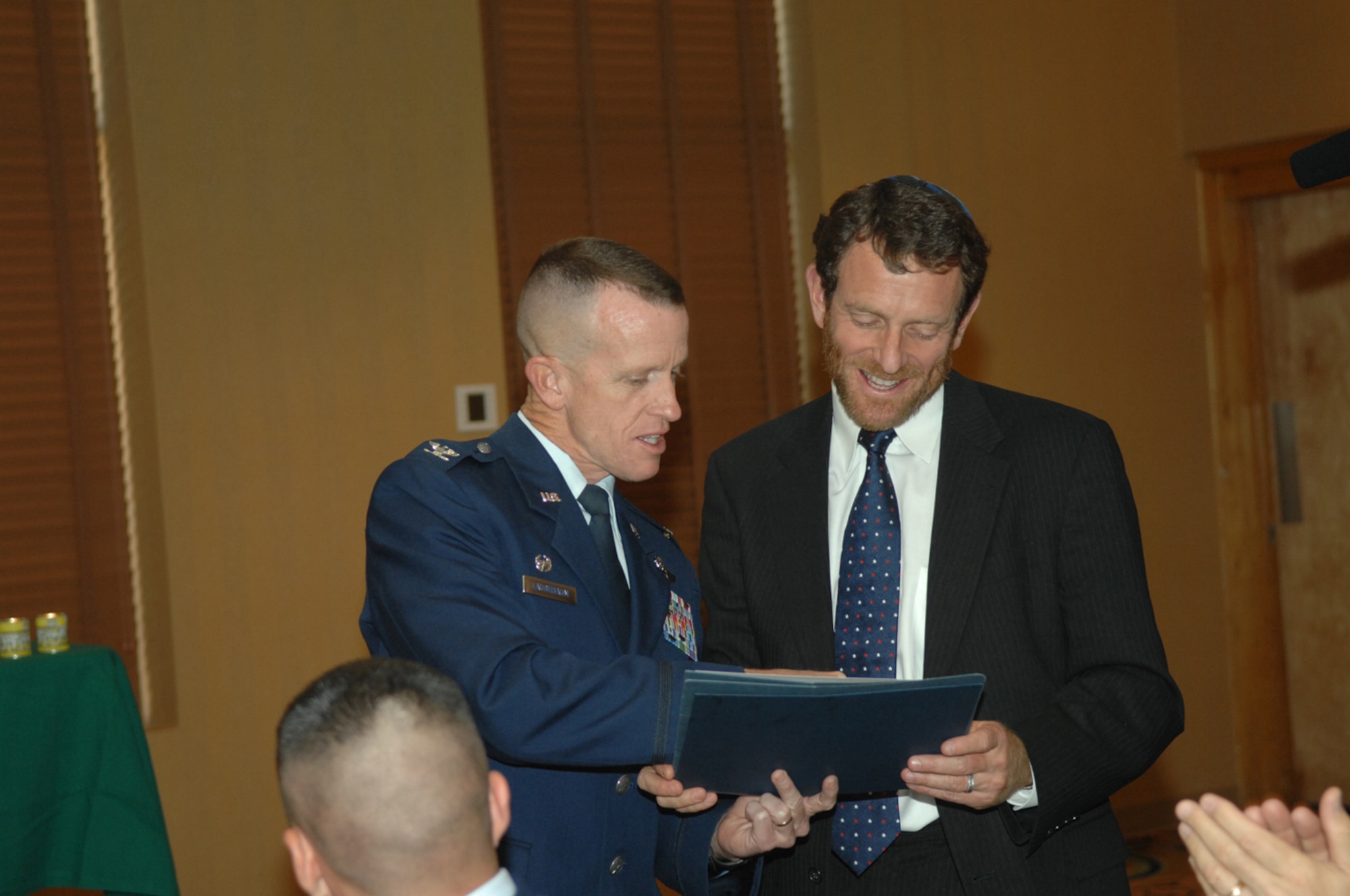 Col. Kent Laughbaum, 355th Fighter Wing commander, greets Rabbi Sam Cohon after the Holocaust Observance Luncheon at the O' Club April 16. Six Holocaust survivors thought back to their days of the Holocaust with Airmen from D-M at the Officer’s Club to educate them on what they had to go through to survive the hardships of those times. (U.S. Air Force photo by Airman 1st Class Noah R. Johnson)