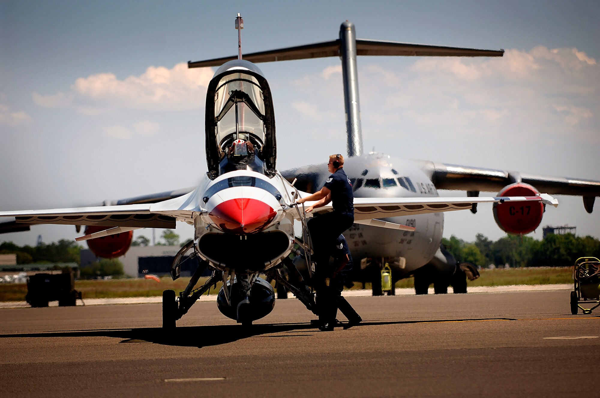 Tech. Sgt. David Batterson climbs up to greet Thunderbird Five upon arrival to the Charleston AFB flightline Monday. Sergeant Batterson is a crew chief for the Thunderbirds who will perform at the 2008 "Wings Over Charleston" Air Expo at Charleston AFB Saturday. (U.S. Air Force Photo/Senior Airman Nicholas Pilch)