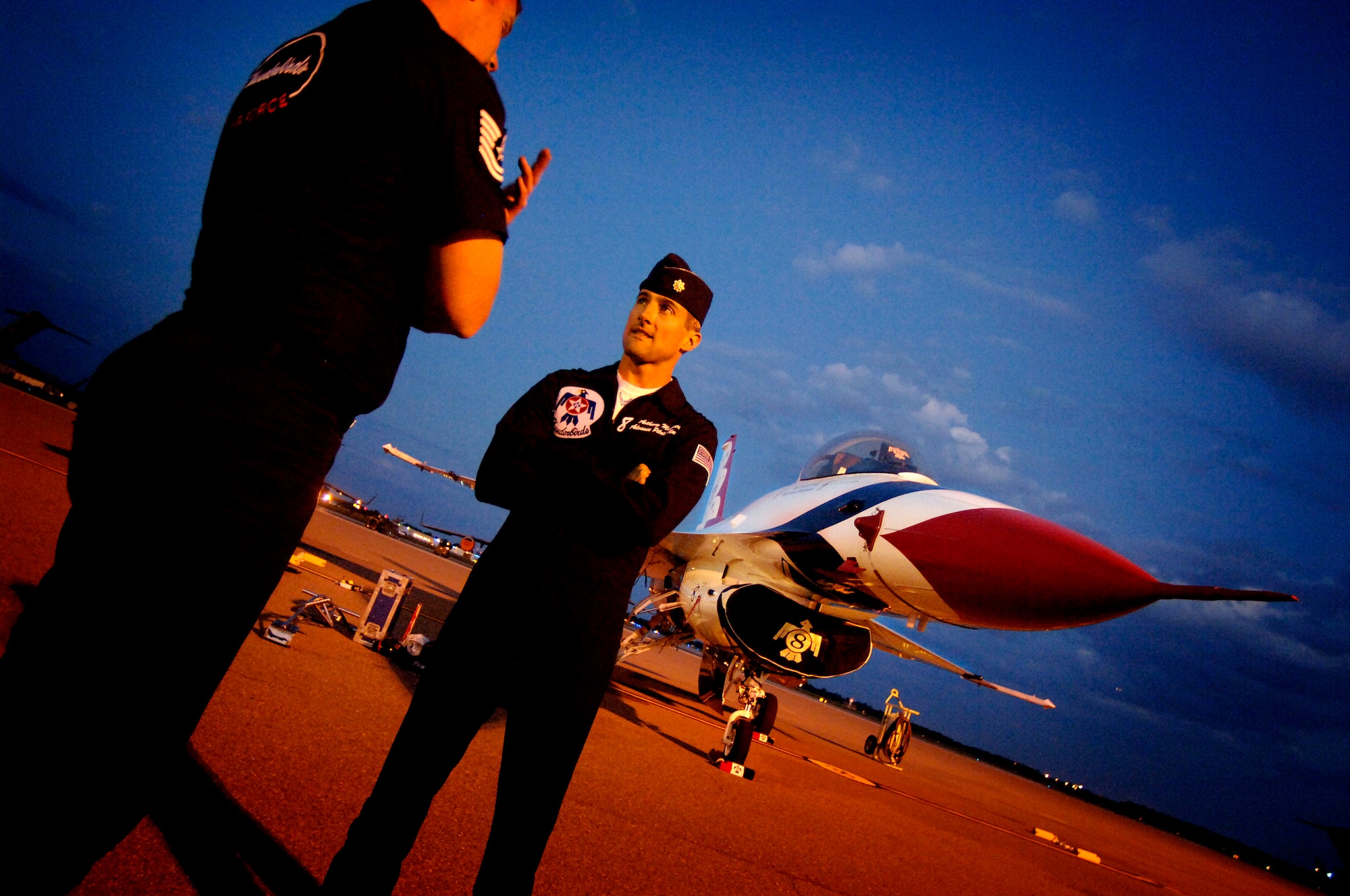 Tech. Sgt.David Batterson and Maj. Anthony Mulhare prepare to leave Thunderbird Eight parked overnight on the Charleston AFB flightline Sunday. Sergeant Batterson is a crew chief with the Thunderbirds advance team and Major Mulhare is the pilot of Thunderbird Eight. The Thunderbirds will be performing at the "Wings Over Charleston" 2008 Air Show Saturday.  (U.S. Air Force photo/Senior Airman Nicholas Pilch) 