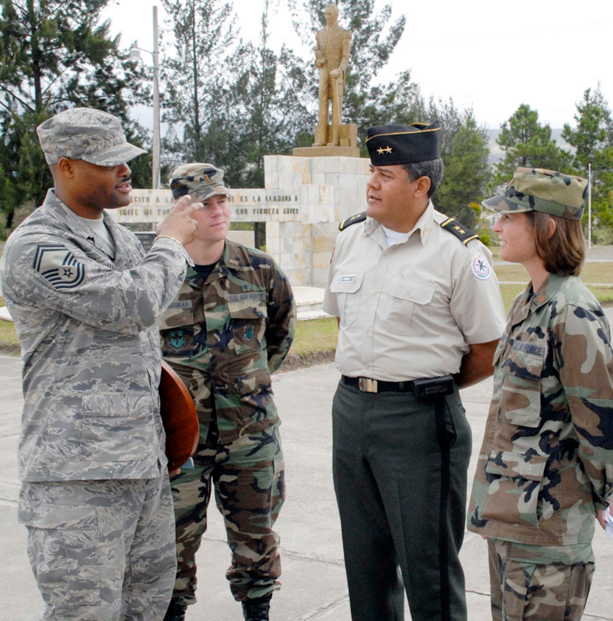 Senior Master Sgt. Les Bramlett, 2nd Lt. Zack Kalinauskis and Maj. Tiffany Morgan visit with Honduran Lt. Col. Raynel Funes during an information exchange and tour of the Honduran military training academy in Tegucigalpa, Honduras. Sergeant Bramlet, Lieutenant Kalinauskis and Major Morgan are members of Joint Task Force-Bravo from Soto Cano Air Base, Honduras. Colonel Fuenes is the Honduran Military Training Academy deputy director. (U.S. Air Force photo/Tech. Sgt. William Farrow) 