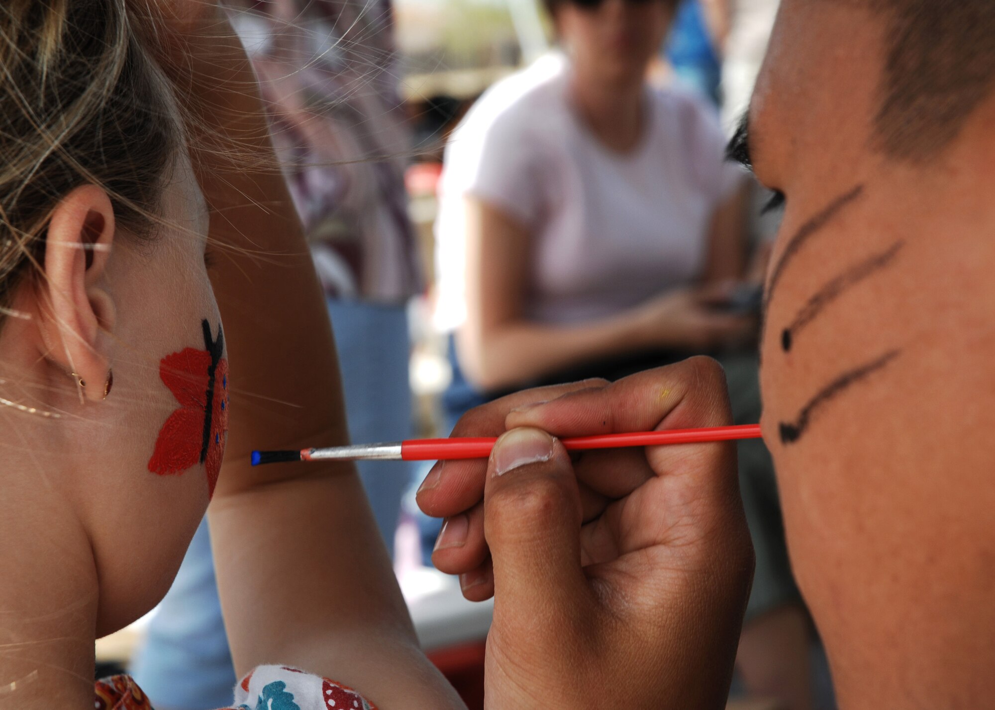 CANNON AIR FORCE BASE N.M.-- Abby Brown gets her face painted during the annual kite karnival April 19 at Doc Stewart Park. The Kite Karnival is a Community Center "Let's Celebrate!" trademark event that attracts close to 2,500 people from the surrounding area to experience kite flying at its best.  (U.S. Air Force photo/Airman 1st Class Liliana Moreno)  