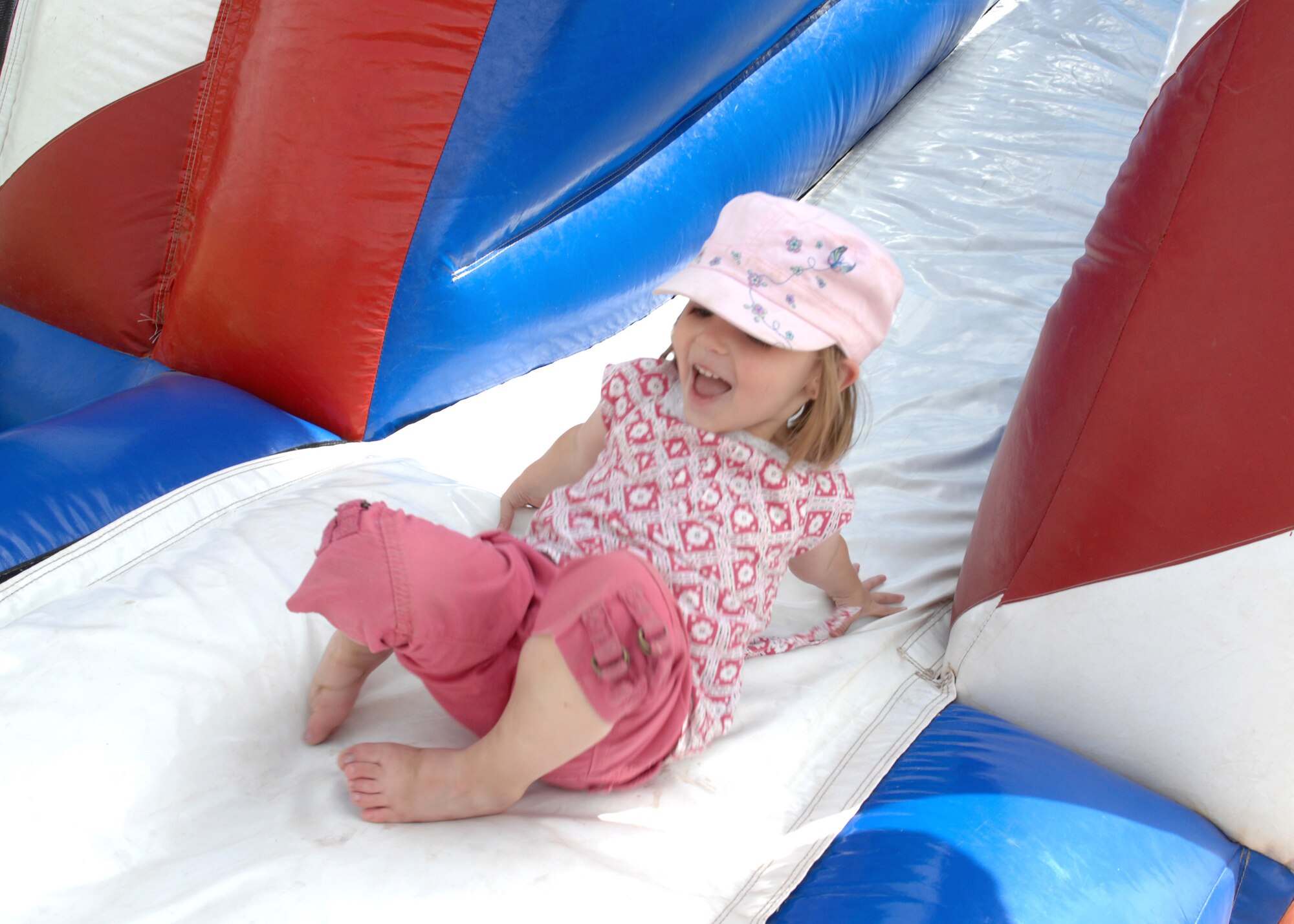 CANNON AIR FORCE BASE N.M.--  Jenna Brown slides down the jumping balloon during the annual Kite Karnival April 19 at Doc Stewart Park. The Kite Karnival is a Community Center "Let's Celebrate!" trademark event that attracts close to 2,500 people from the surrounding area to experience kite flying at it's best. (U.S. Air Force photo/Airman 1st Class Evelyn Chavez)  