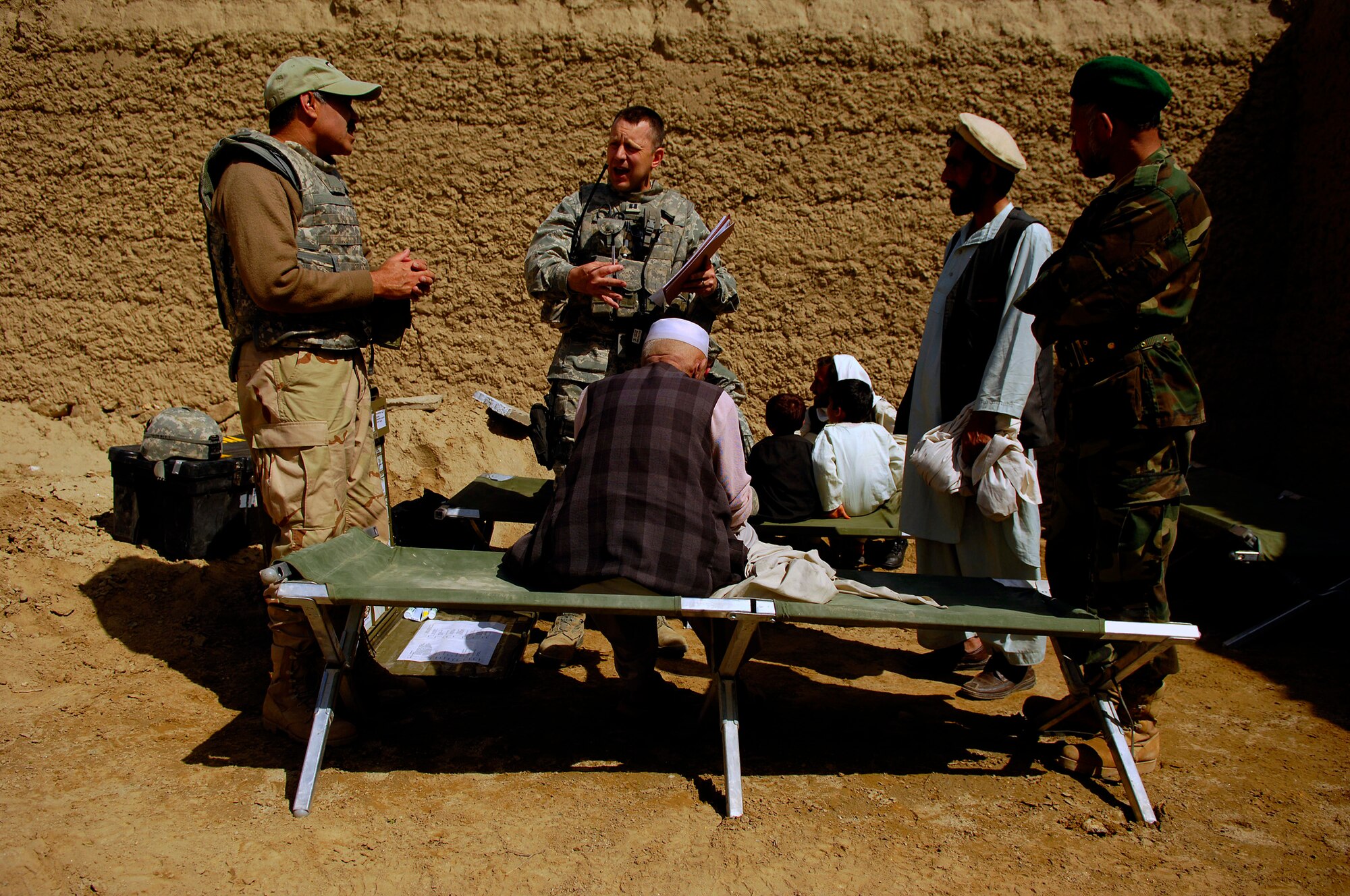 U.S. Air Force Capt. Marshall Fiscus talks with the interpreter about the patient?s condition April 19, 2008, during a Village Medical Outreach at the Joybar village conducted by the Provincial Reconstruction Team, Bagram Air Field Afghanistan. Fiscus is the Chief Medical Officer assigned to the PRT and is deployed from Geilenkirchen, Germany. (U.S. Air Force photo by Master Sgt. Andy Dunaway) (Released)
