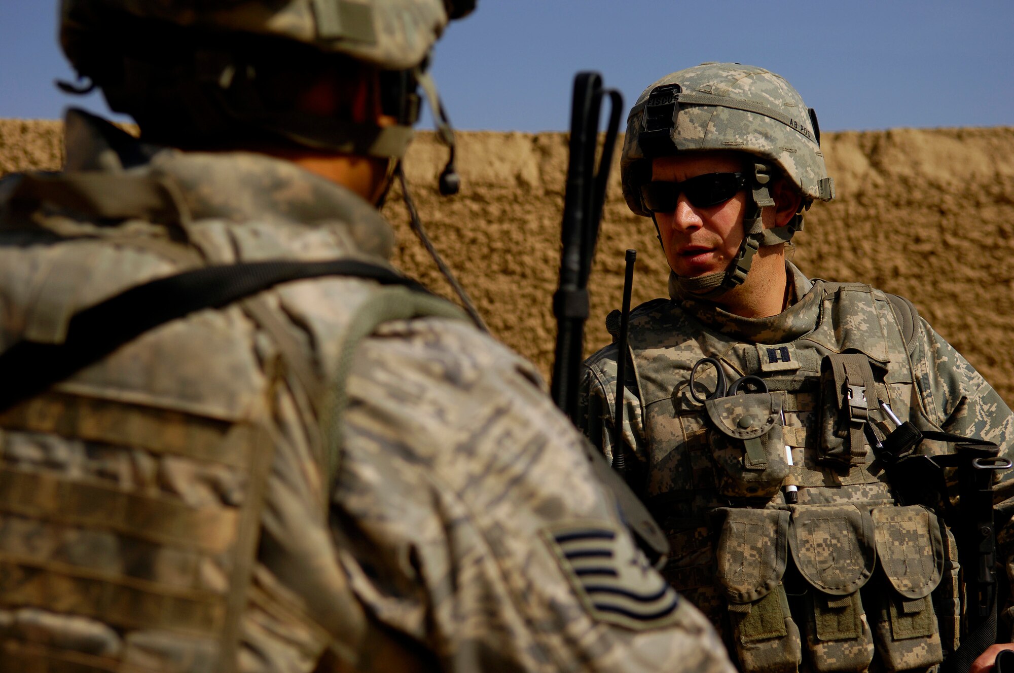 U.S. Air Force Capt. Marshall Fiscus talks with Tech. Sgt. Chris Padron April 19, 2008, while setting up for a Village Medical Outreach at the Joybar village conducted by the Provincial Reconstruction Team, Bagram Air Field Afghanistan. Fiscus is the Chief Medical Officer assigned to the PRT and is deployed from Geilenkirchen, Germany and Pardon is the Non Commissioned Officer in Charge Police Technician Advisor Team, PRT and is deployed from the 27th Special Operations Security Forces Squadron Cannon, Air Force Base, N.M.(U.S. Air Force photo by Master Sgt. Andy Dunaway) (Released)
