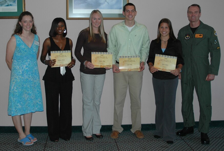 Col. Darryl Roberson, 325th Fighter Wing commander (far right), and Nicole Van Pelt, Officers’ Spouses’ Club president (far left), pose with OSC scholarship recipients Ronnica Amour, Andrea Oliver, Sean Hicks and Sierra Seaman during a reception in their honor Tuesday at the Heritage Club. 