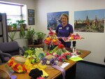 Karen Lachat, education services officer, pauses with several Fiesta-decorated hats during Randolph Education Services office's hat decorating contest recently. Education partners Embry-Riddle Aeronautical University and Wayland Baptist University collaborated on how to kick of the week-long Fiesta celebration. Several colleges and universities entered the hat contest, with eight hats adorning festive ornaments and decorative creations. Judges decided the hat decorated by Wayland Baptist University employees best represented the Fiesta ideal. (Photo by Connie Outlaw)