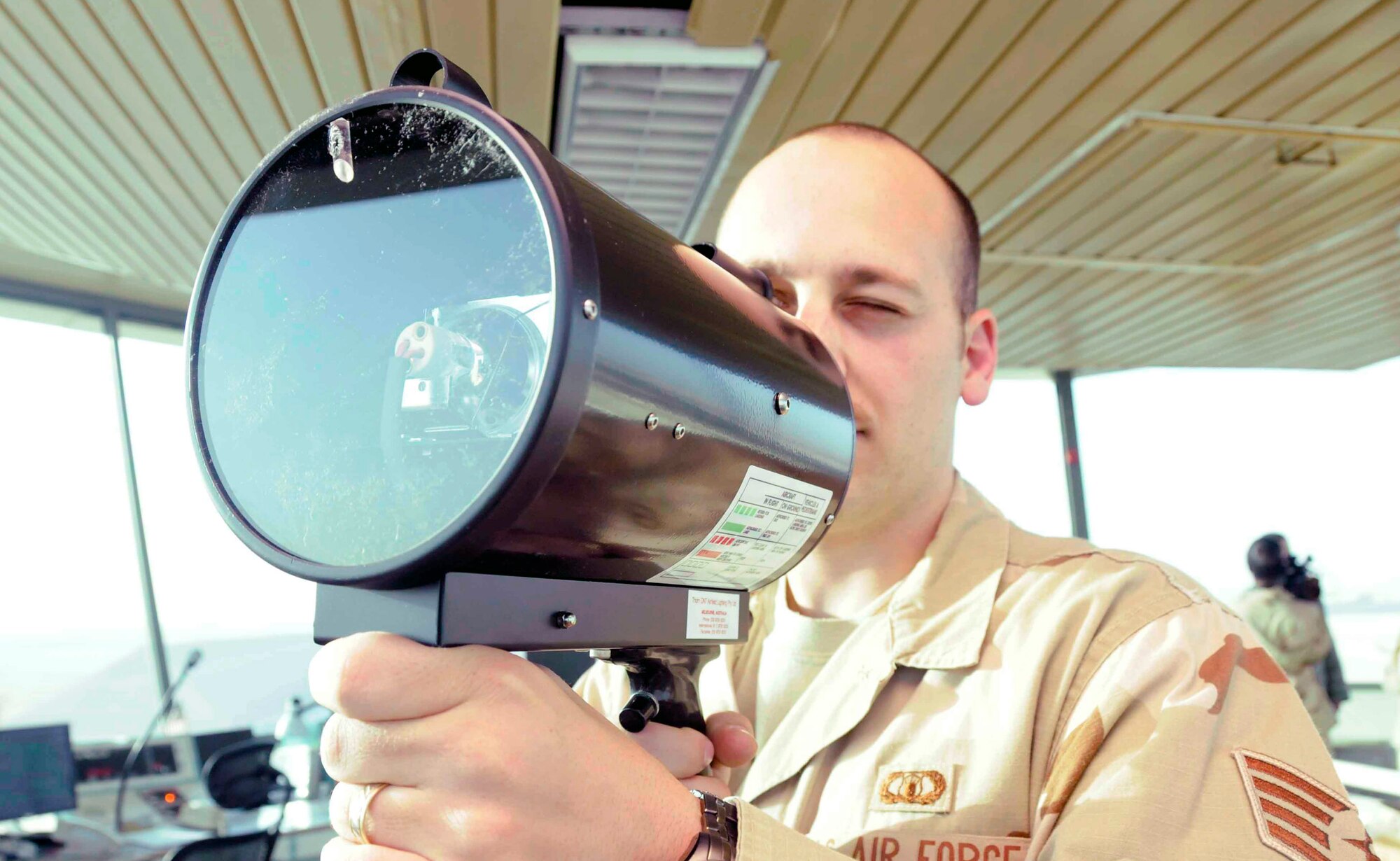 Staff Sgt. Bryce Hamilton demonstrates the use of a light signal to communicate with vehicles that have lost radio contact with the tower April 15 at a Southwest Asian air base. Sergeant Hamilton is assigned to the 379th Expeditionary Operations Support Squadron. (U.S. Air Force photo/Senior Airman Domonique Simmons) 

